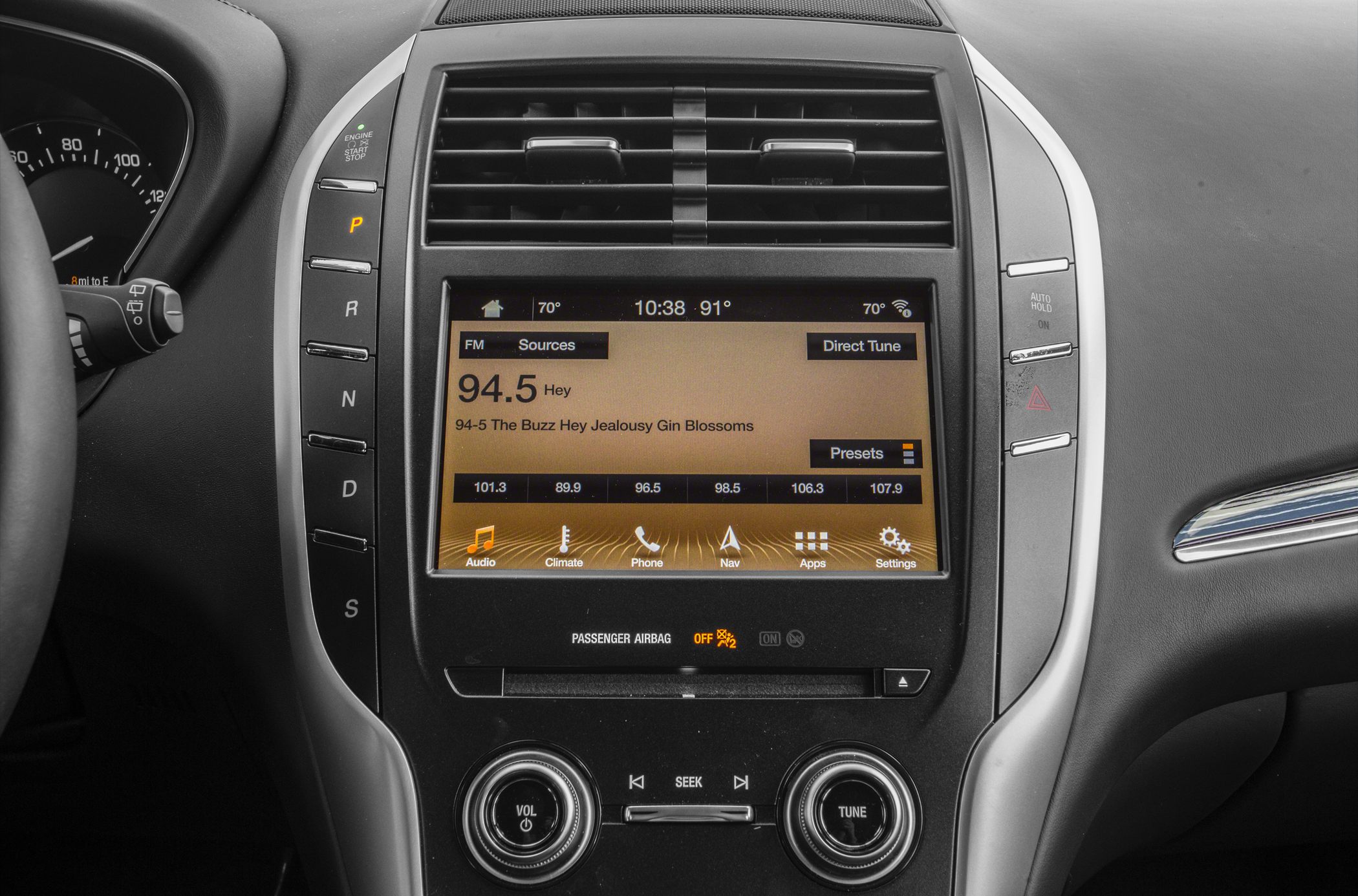 Center console with touchscreen infotainment and vertical gear selector panel.
