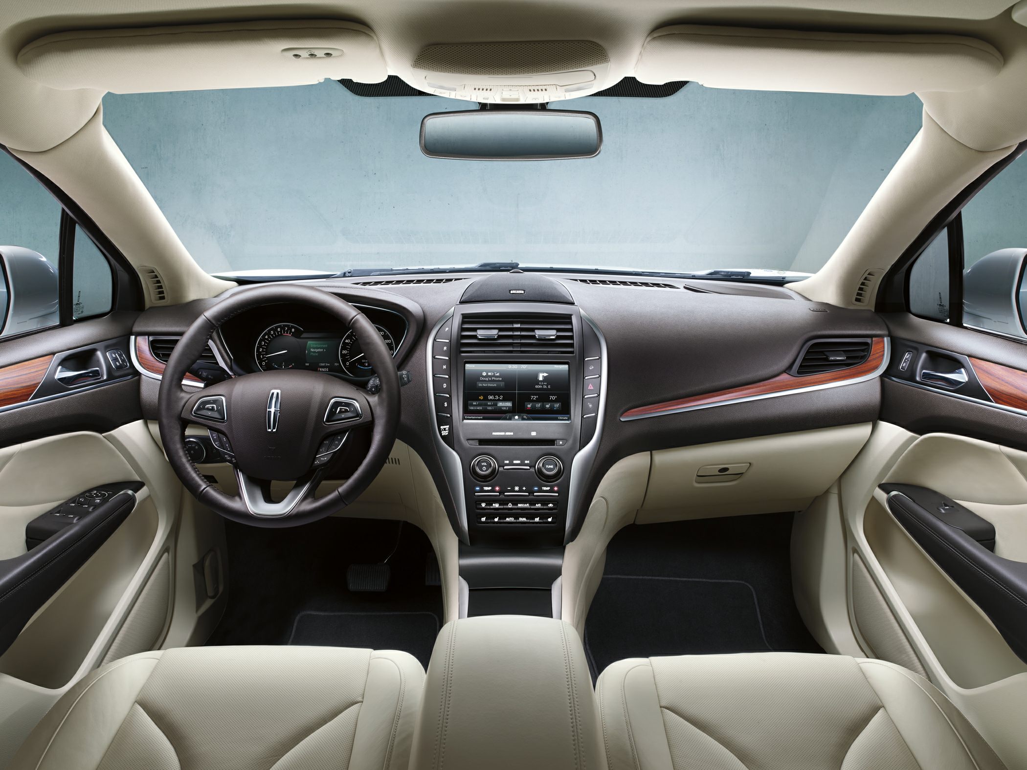 Luxury car interior with steering wheel and touchscreen dashboard