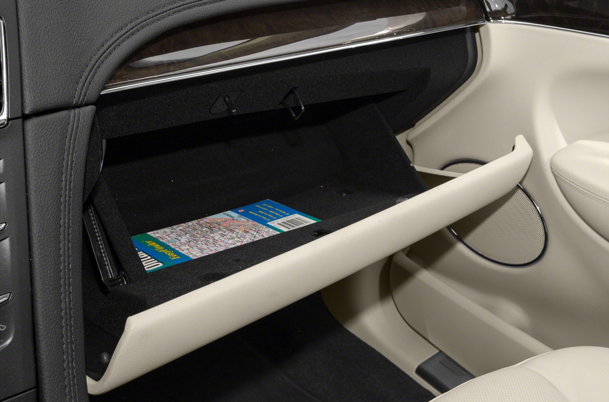 Open glove compartment with map inside in car interior