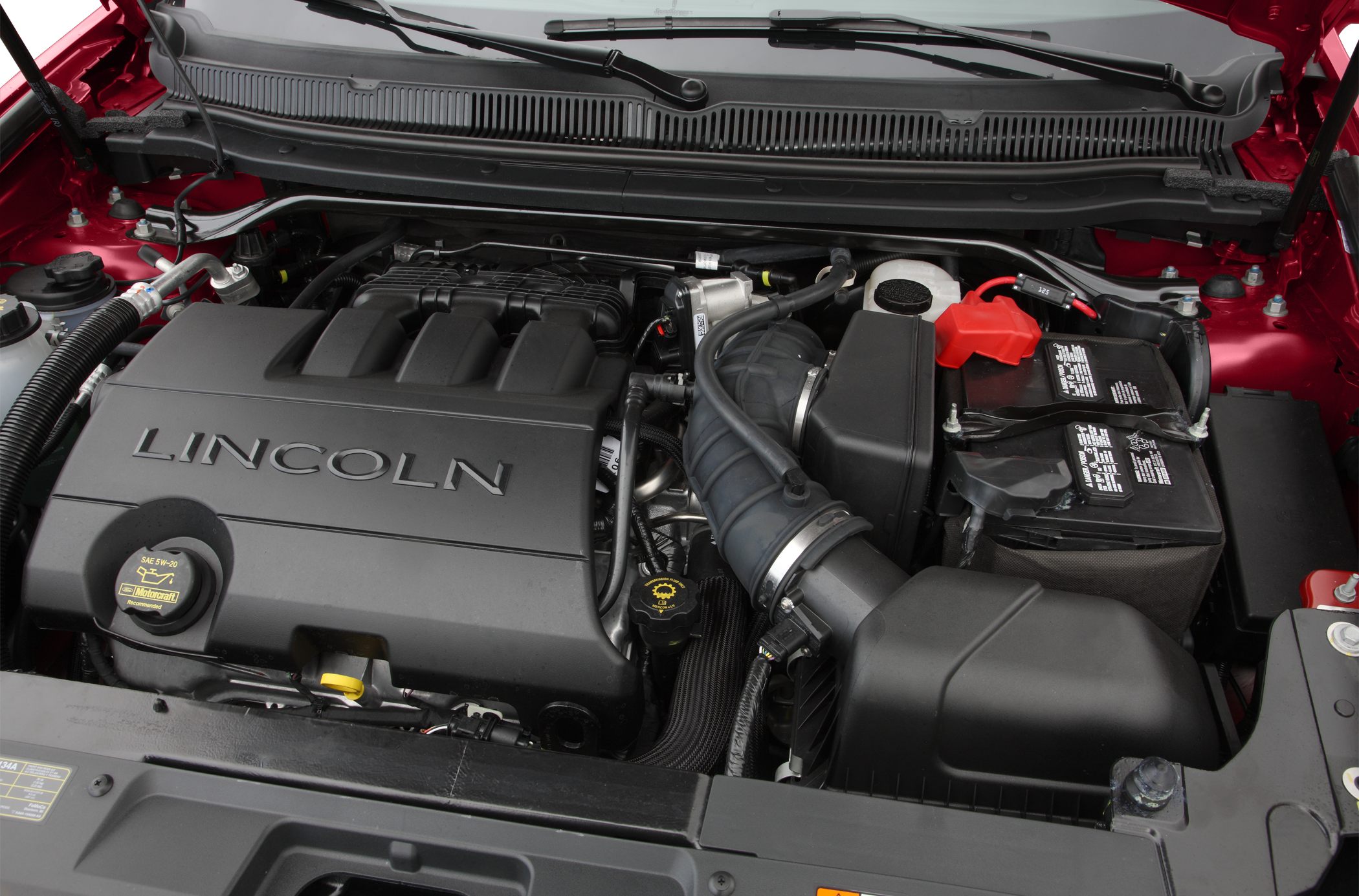 Engine bay with marked engine cover and components
