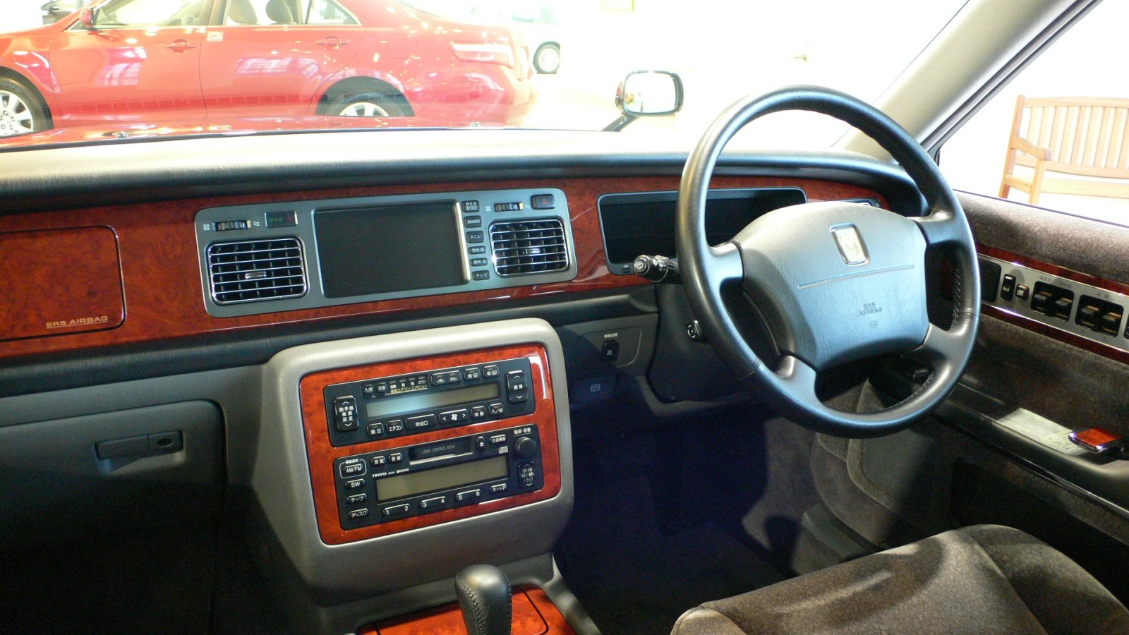 Wood-trimmed dashboard and classic steering wheel in luxury car interior