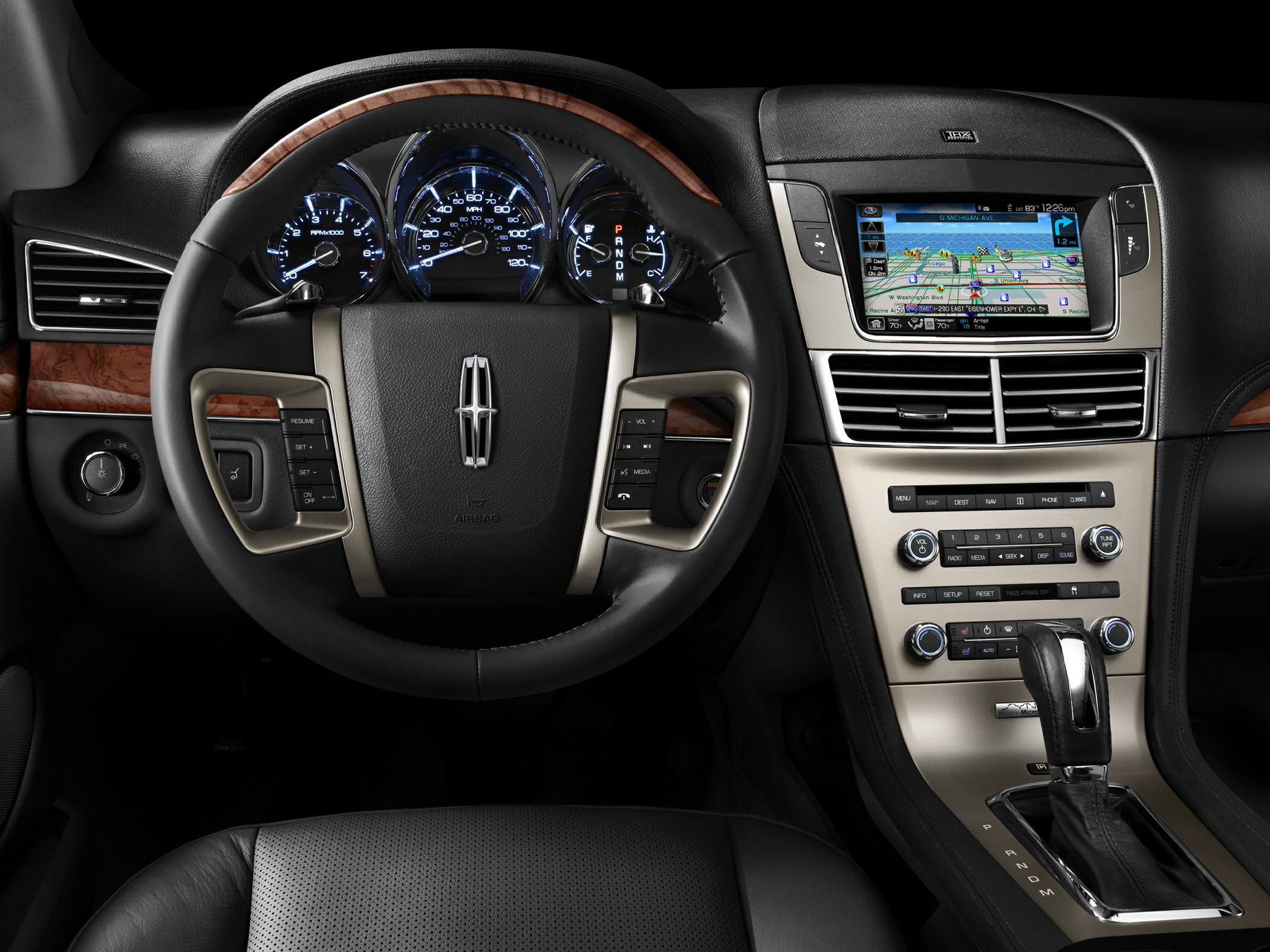 Luxury steering wheel with wood trim and advanced infotainment system.