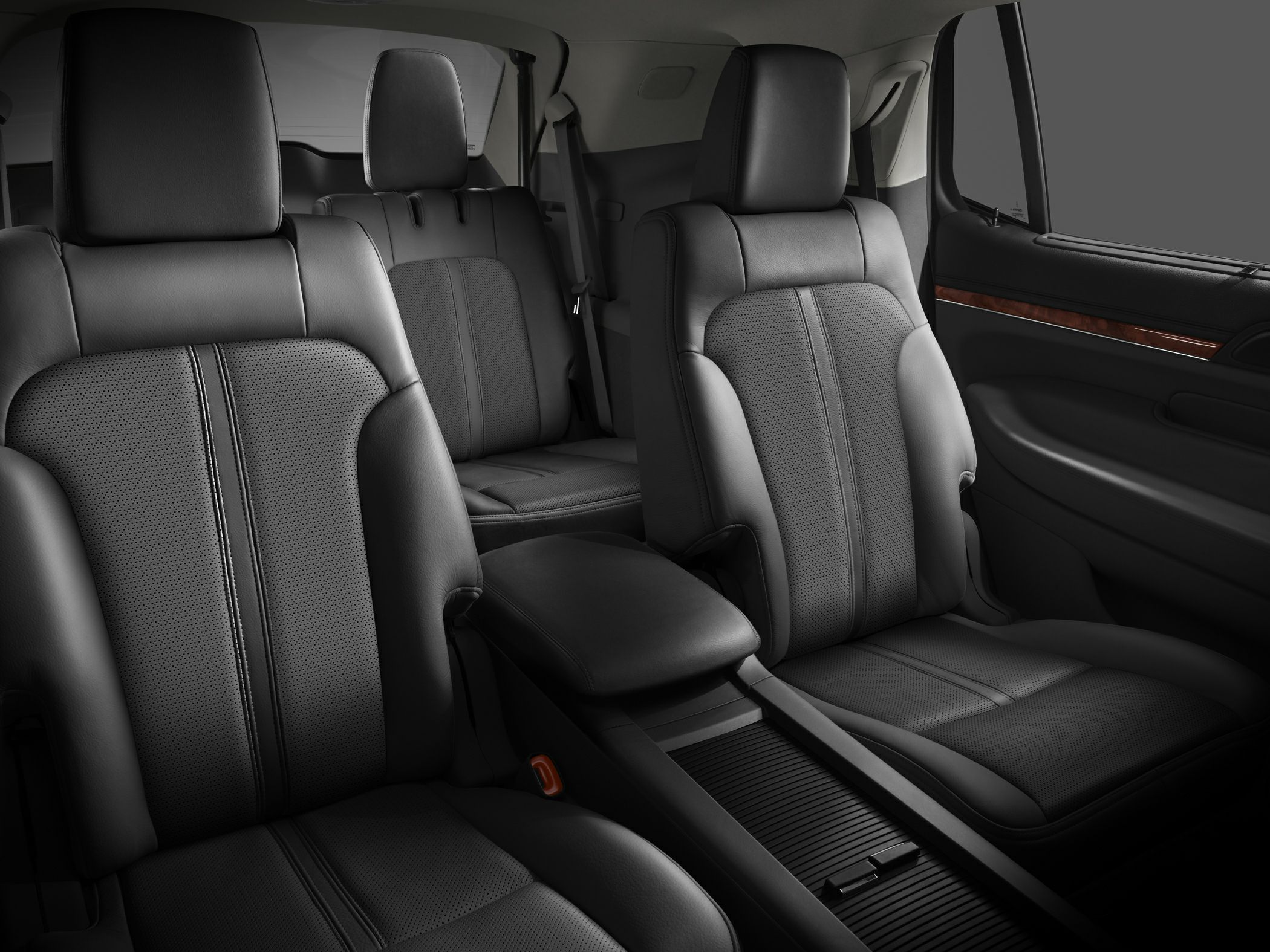 Black leather SUV seats with wood trim and spacious cabin