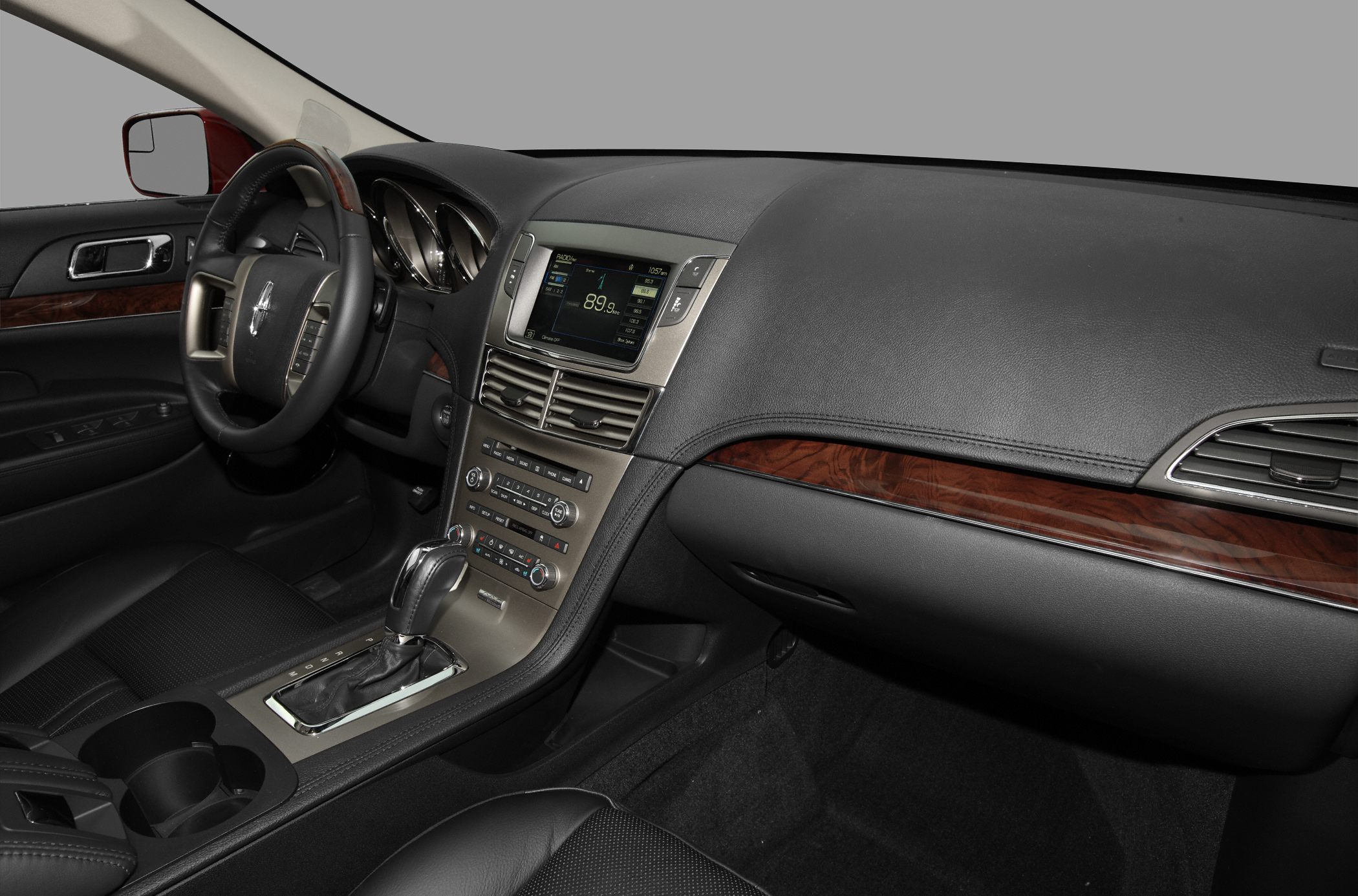 Dashboard with touchscreen, wood trim, leather seats, center console with gear shifter