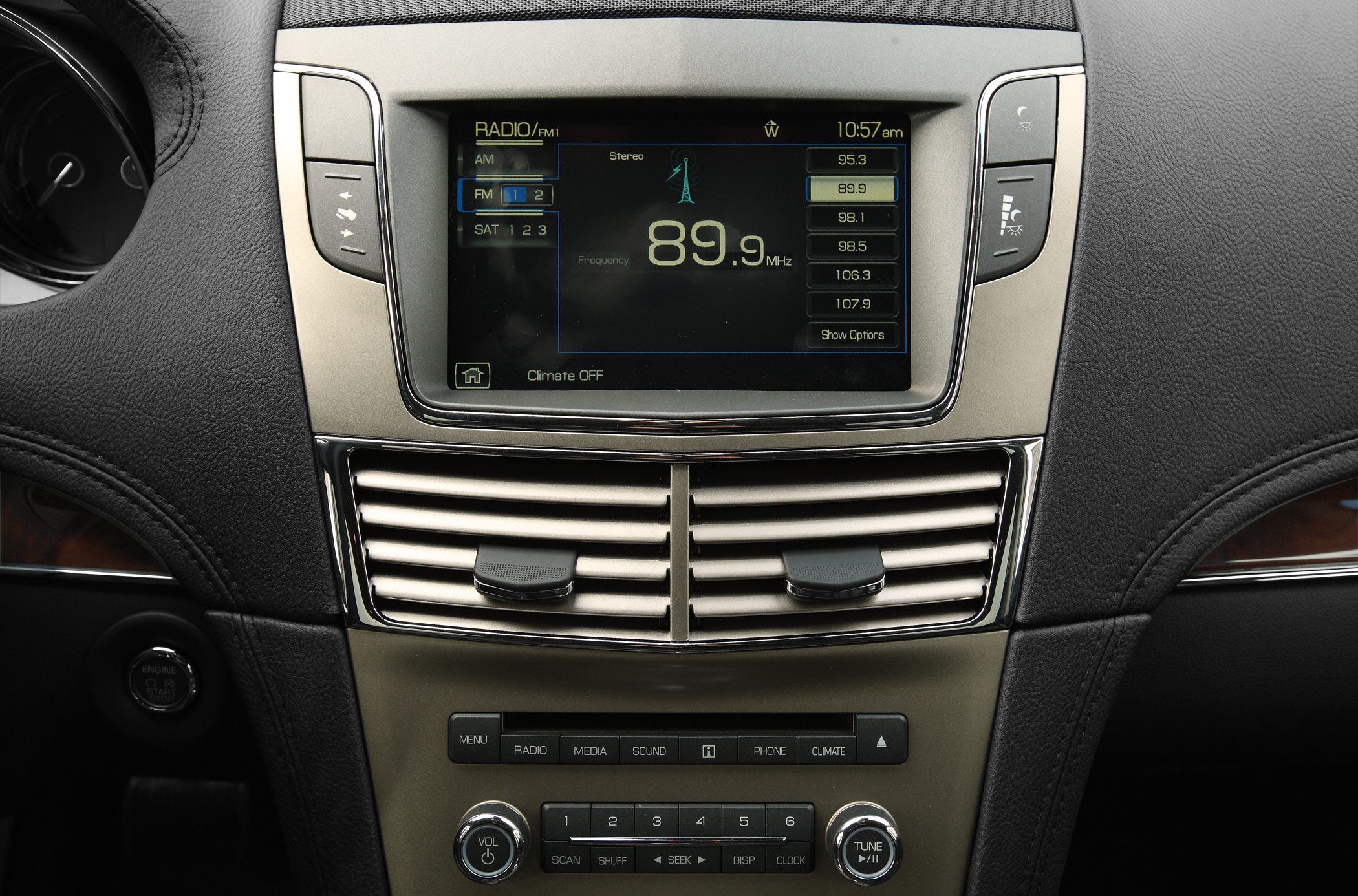 Car dashboard with radio interface and dual climate control vents