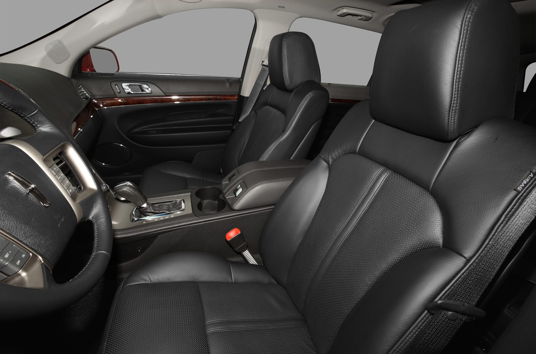 Black leather seats and wood trim interior of a luxury SUV