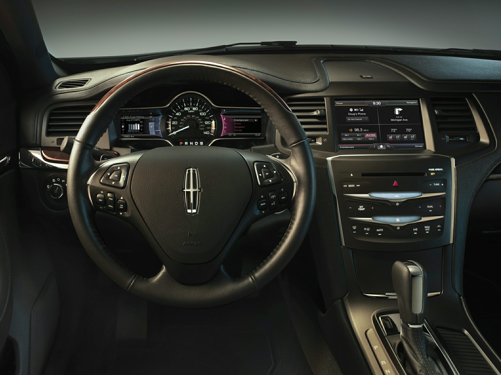 Digital dashboard and infotainment system with steering wheel controls.