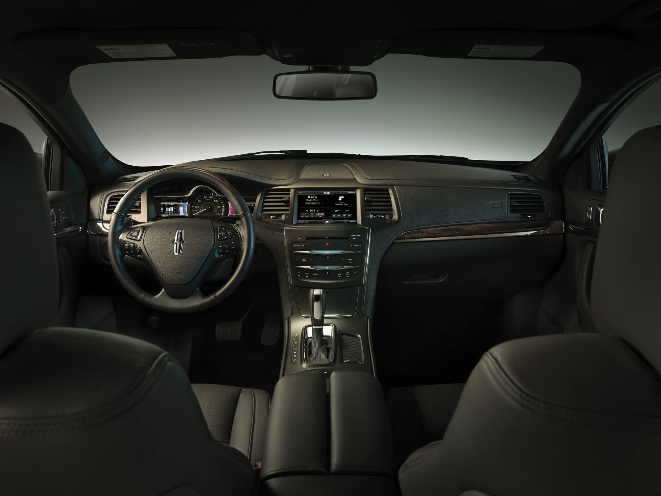 Luxury car interior with leather steering wheel and digital dashboard display