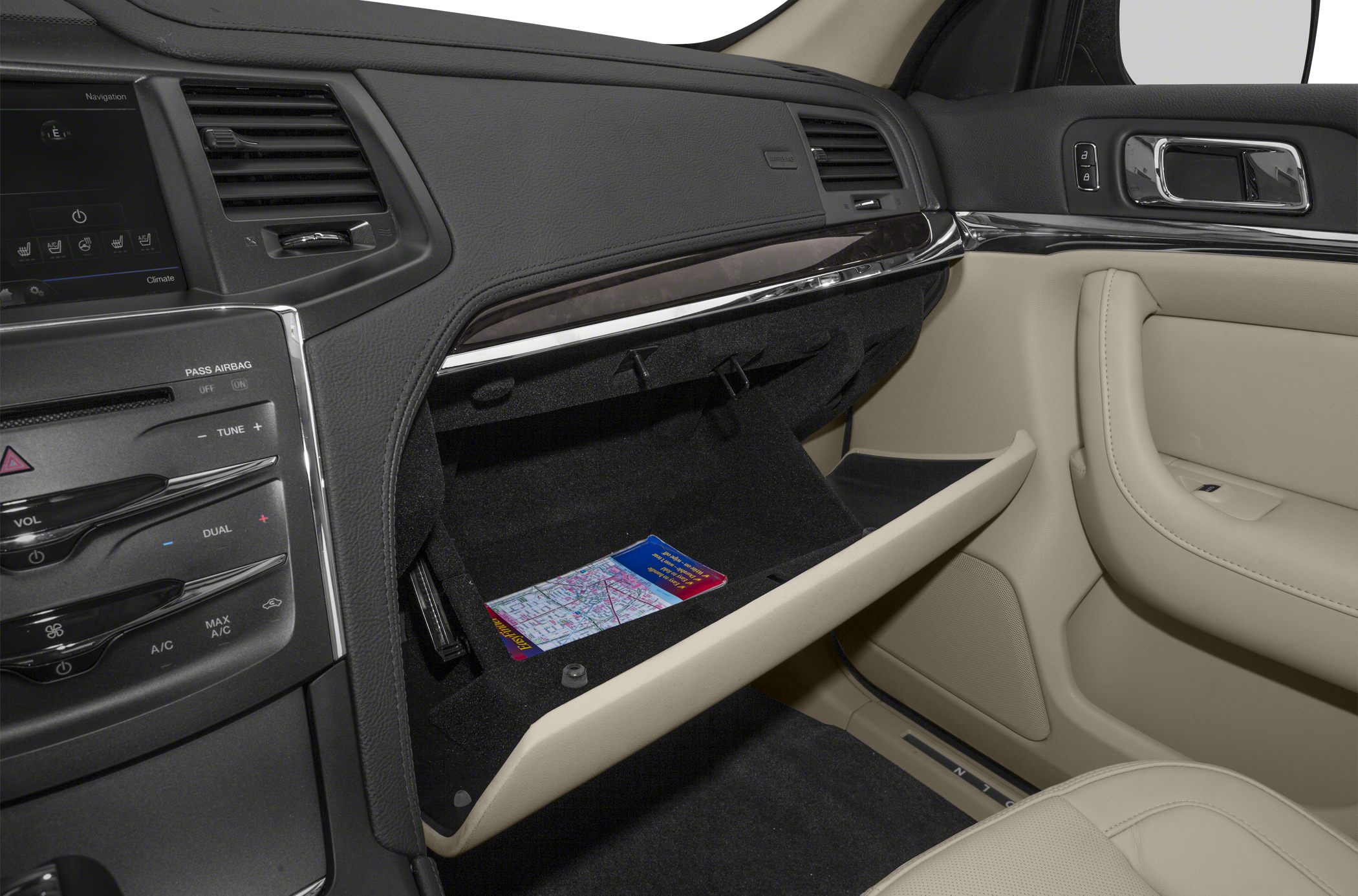 Open glove box and dashboard controls in a luxury car interior