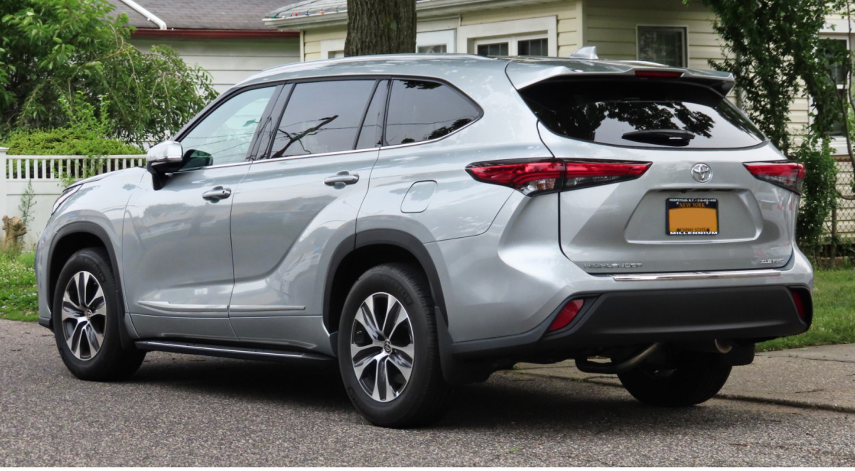 Rear side view of silver SUV with alloy wheels and tinted windows
