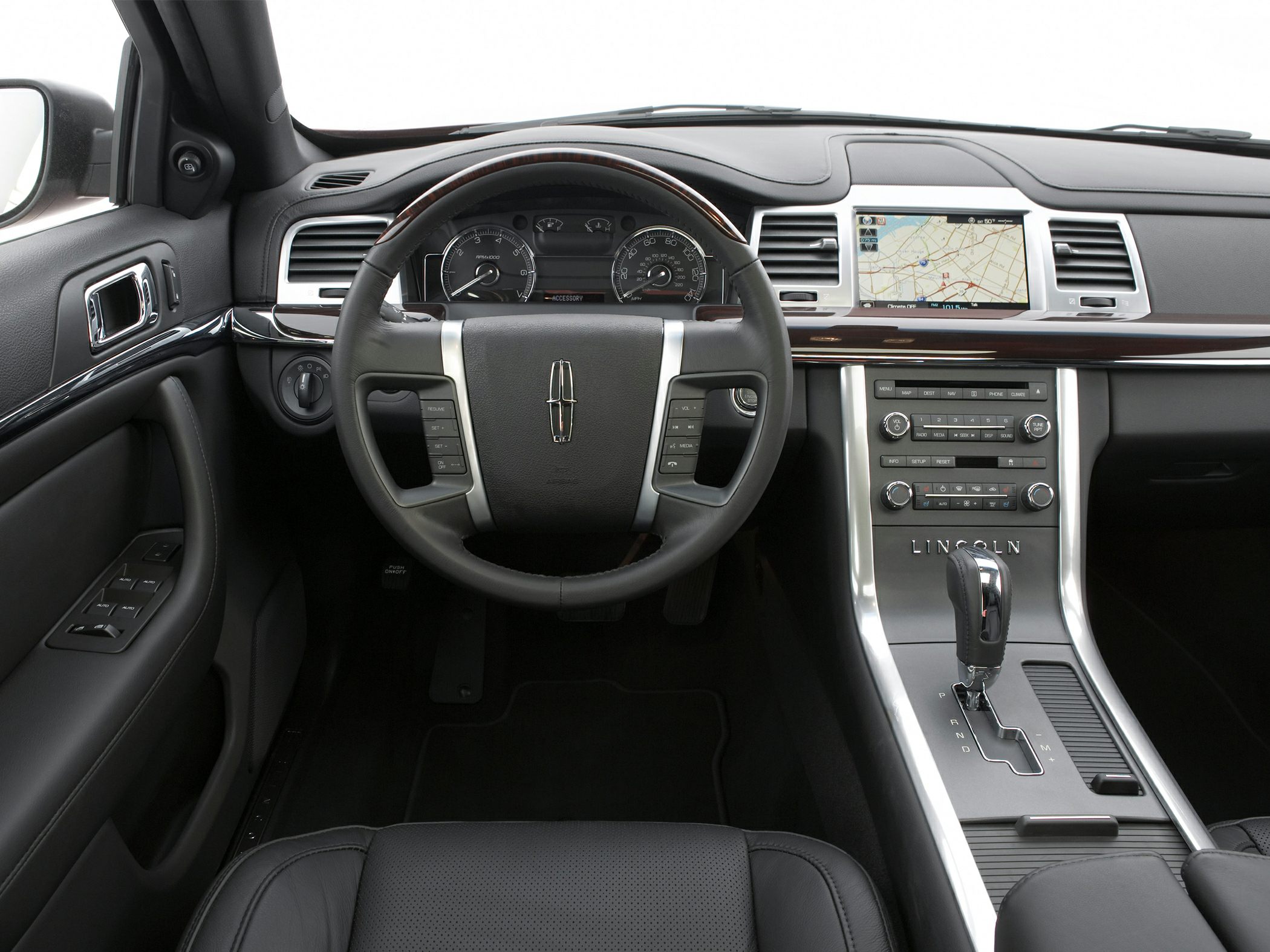 Steering wheel with controls and central navigation display in luxury dashboard