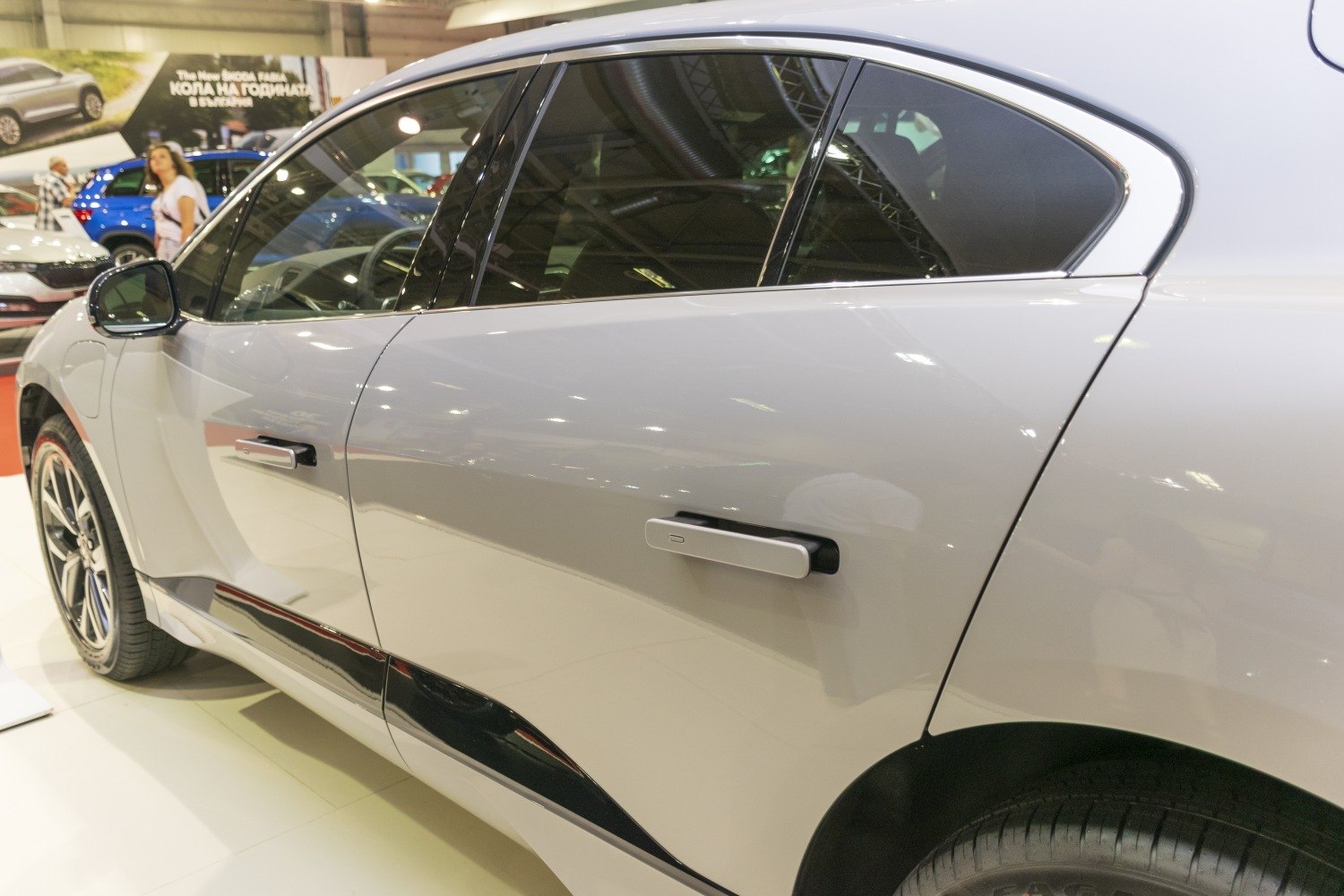Close-up of side door handles and body panel details on a silver vehicle