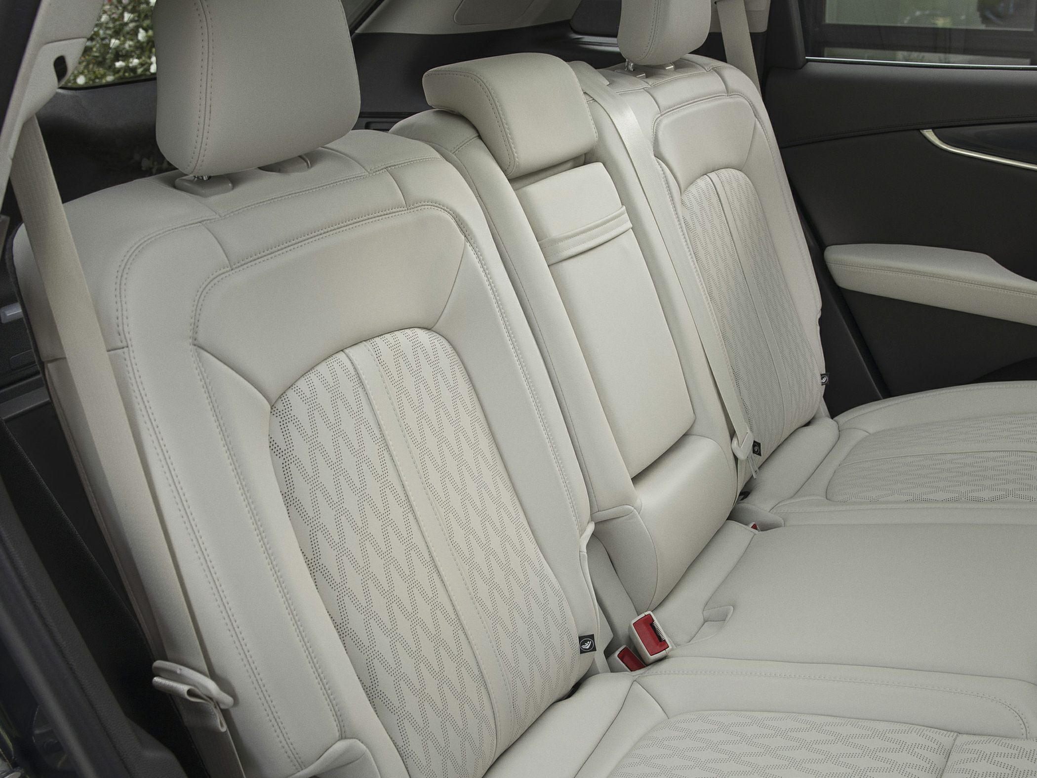 Rear seat interior with luxury leather upholstery and armrest