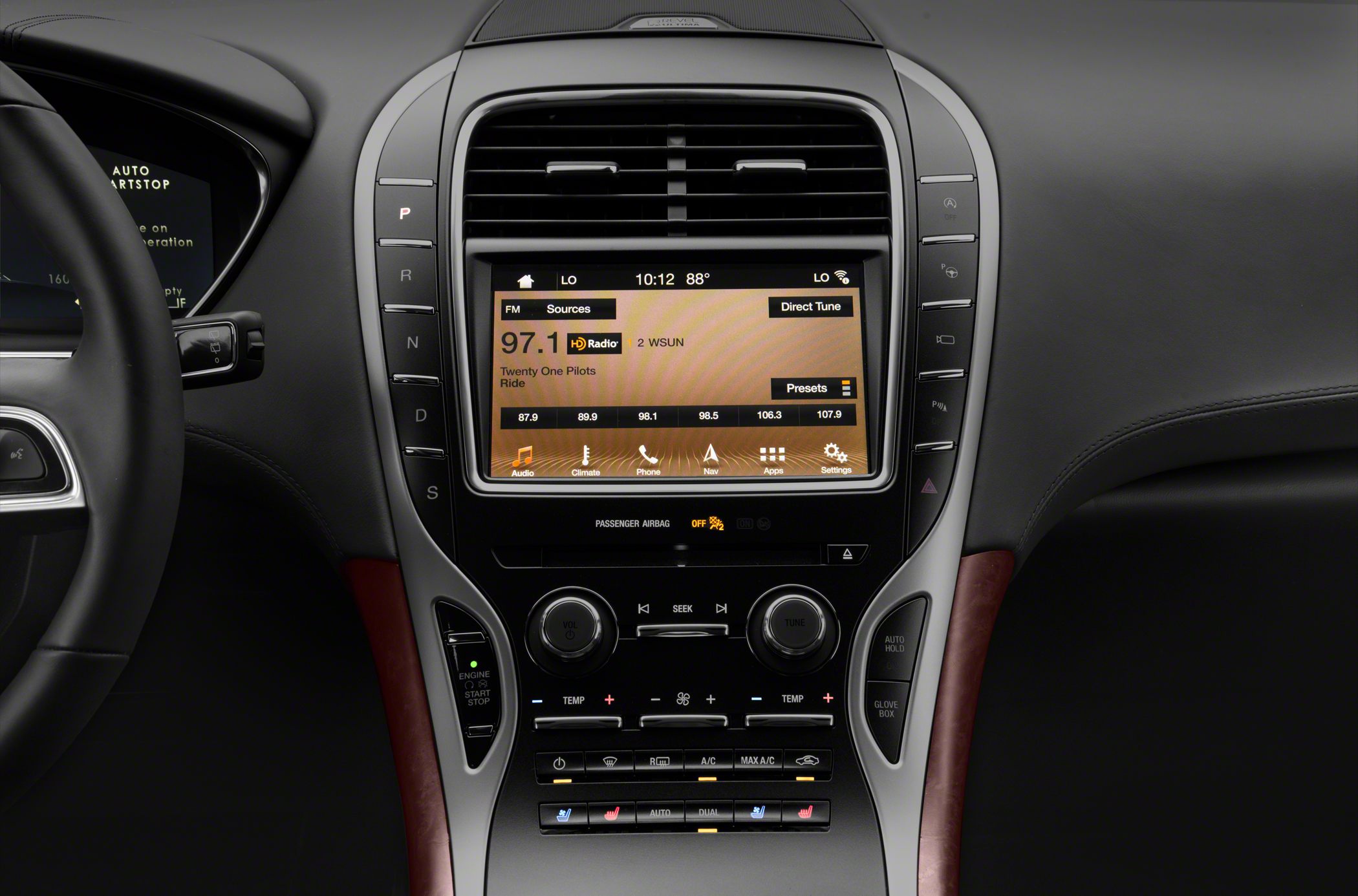 Central touchscreen, gear selector buttons, climate and media controls