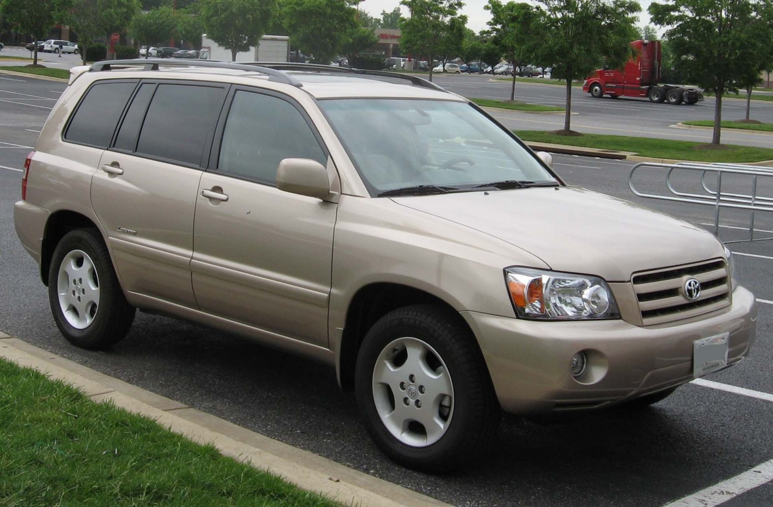 Silver mid-size SUV front side view with roof rails and alloy wheels