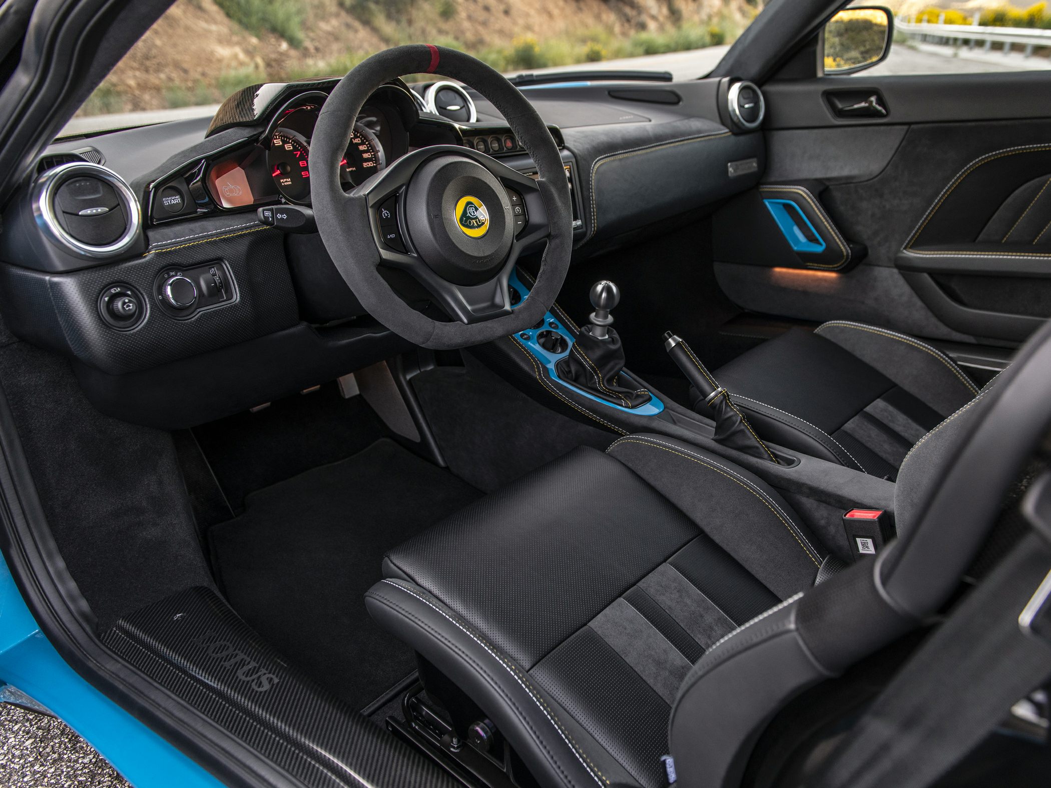 Sporty Alcantara steering wheel and manual gear shifter in premium car interior