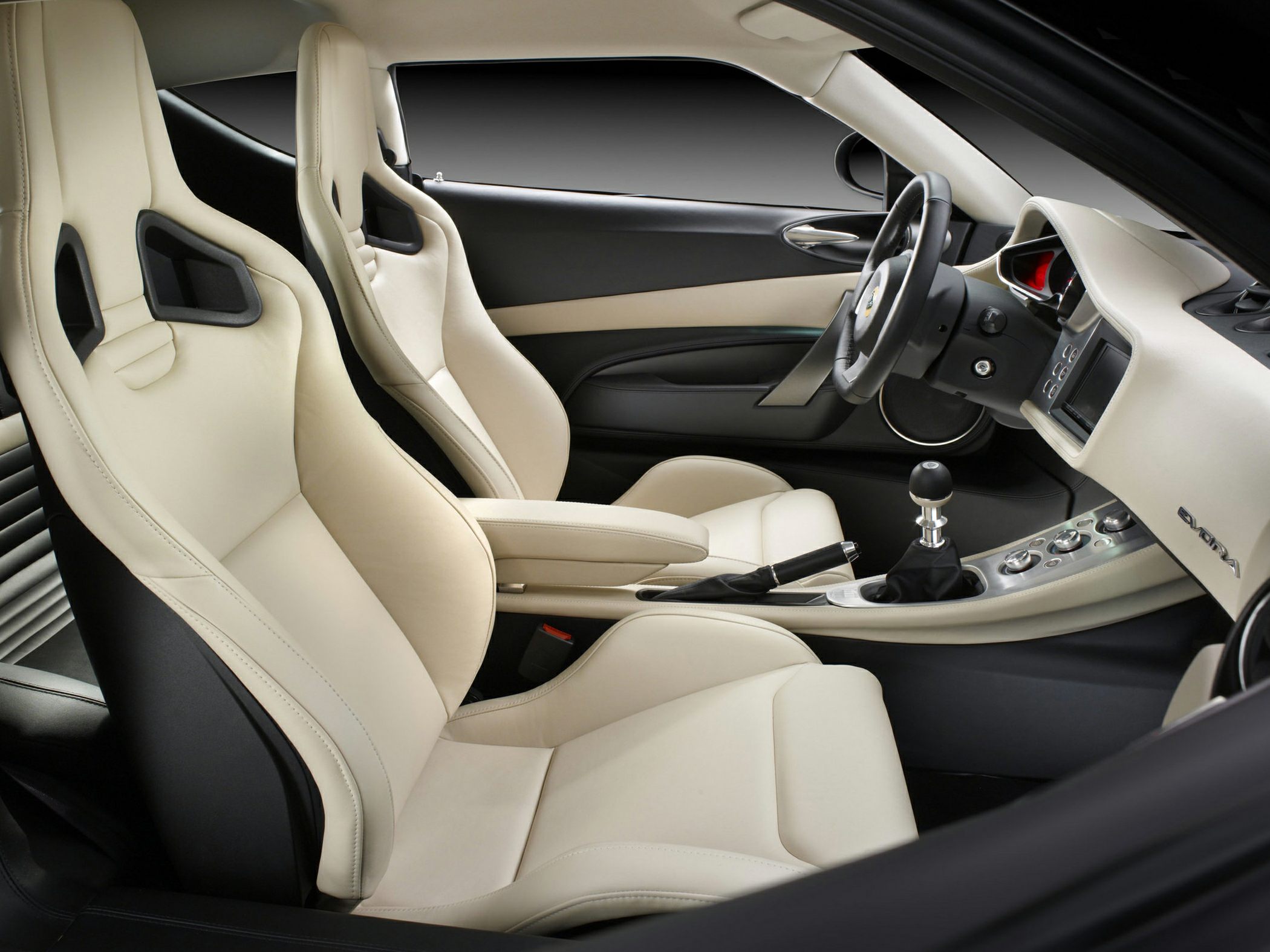 Beige sport seats with manual gear shift and modern dashboard in a sports car interior