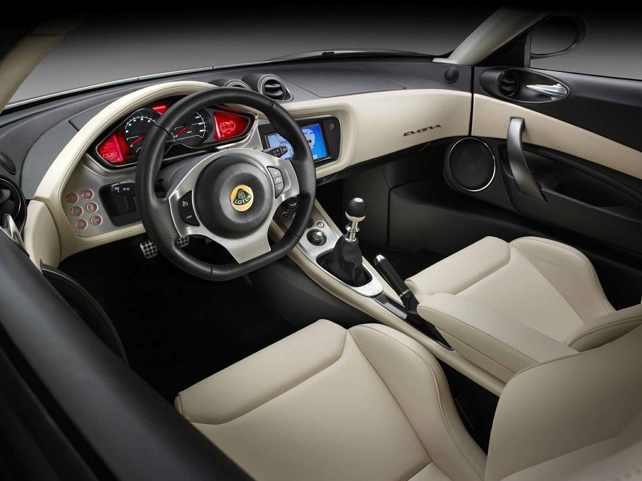 Cream and black dashboard with steering wheel and manual gear shift