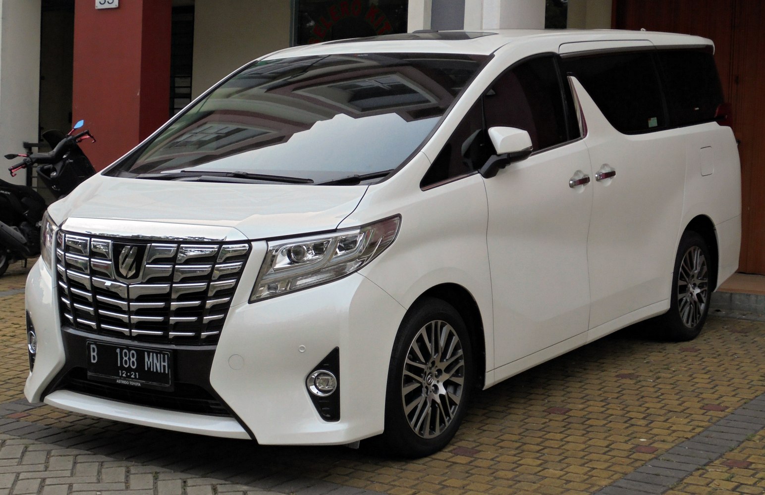Luxury minivan front view with chrome grill and LED headlights