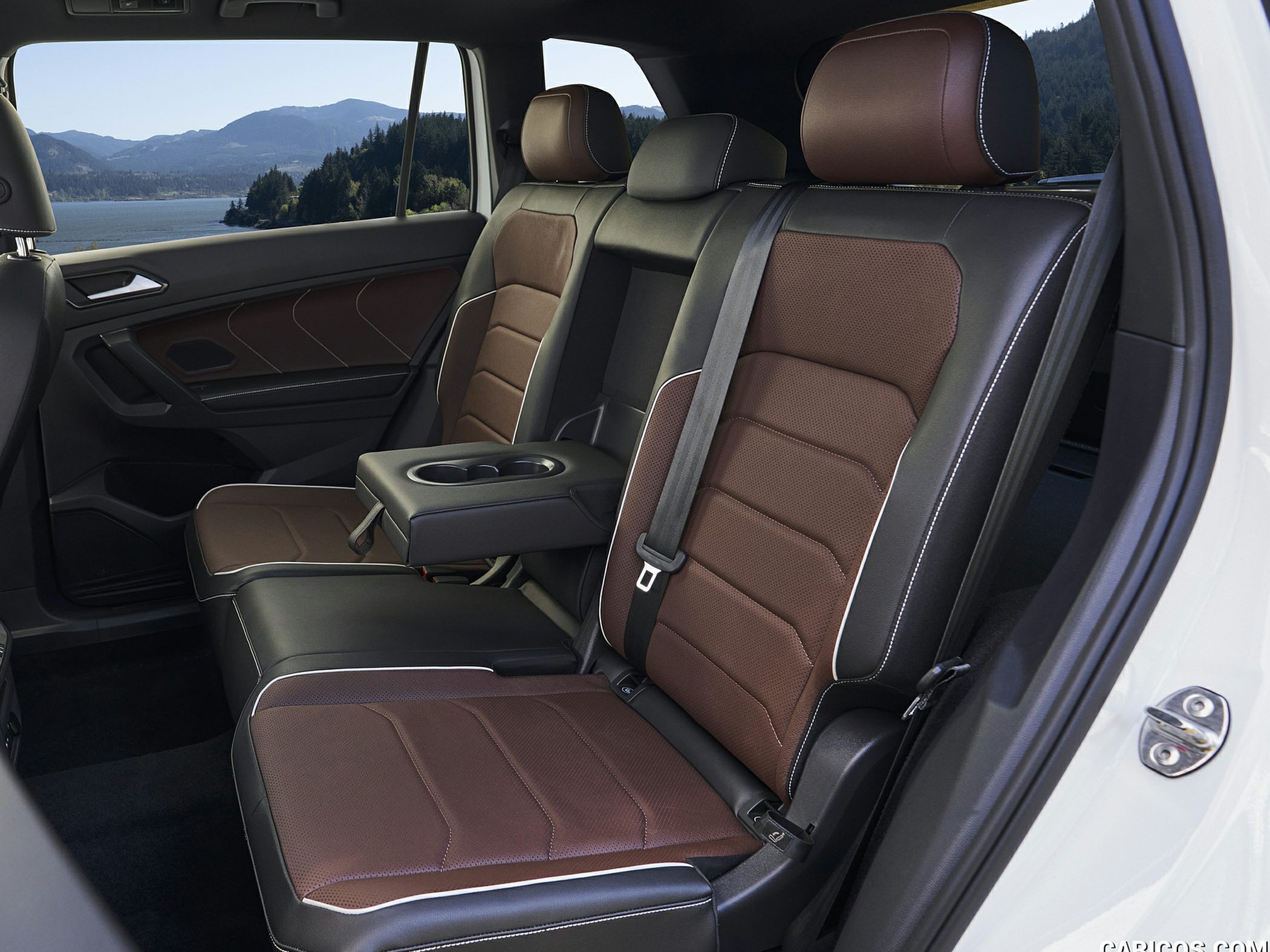 Brown and black leather rear seats with armrest and cup holders