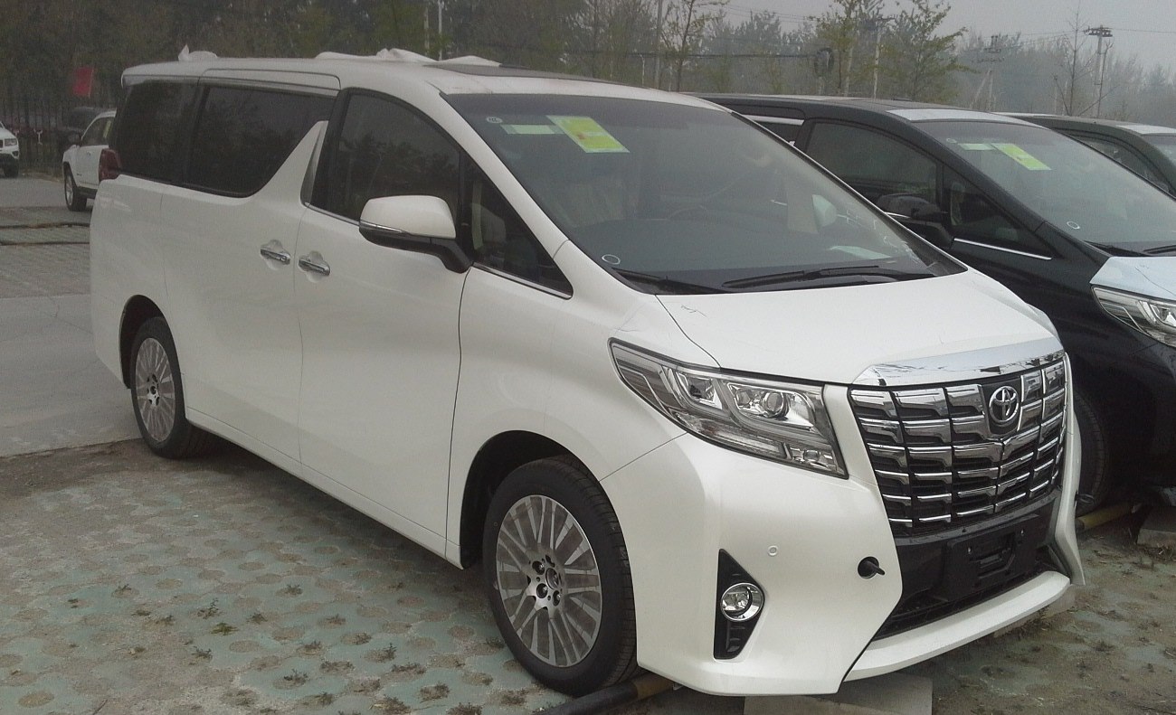 Luxury minivan front and side with chrome grille and sleek headlights