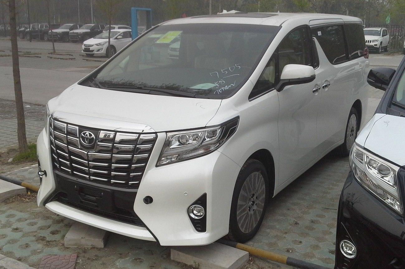 Bold chrome front grille with distinctive headlights on a white luxury minivan.