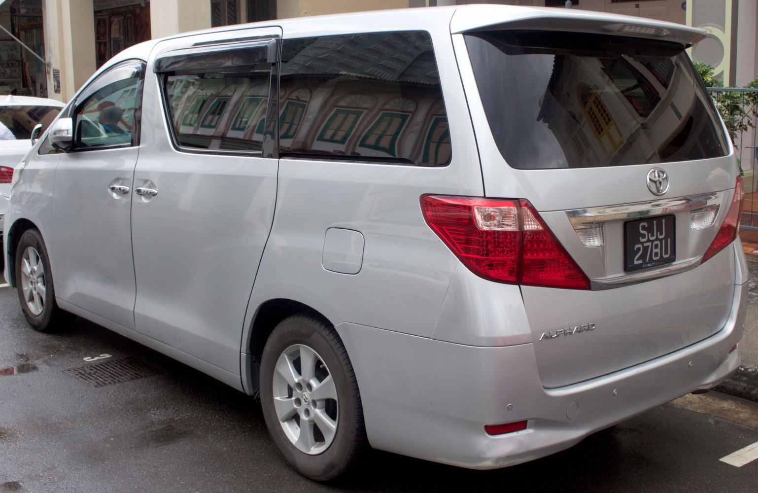 Silver minivan rear and side view with sliding doors and prominent taillights