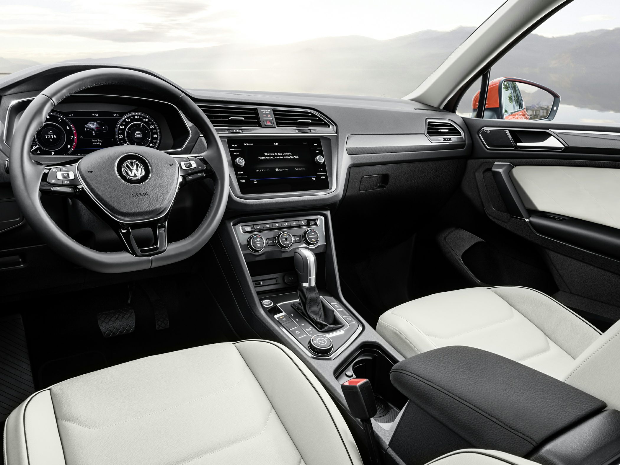 Digital dashboard, touchscreen infotainment, ergonomic steering wheel, beige seats