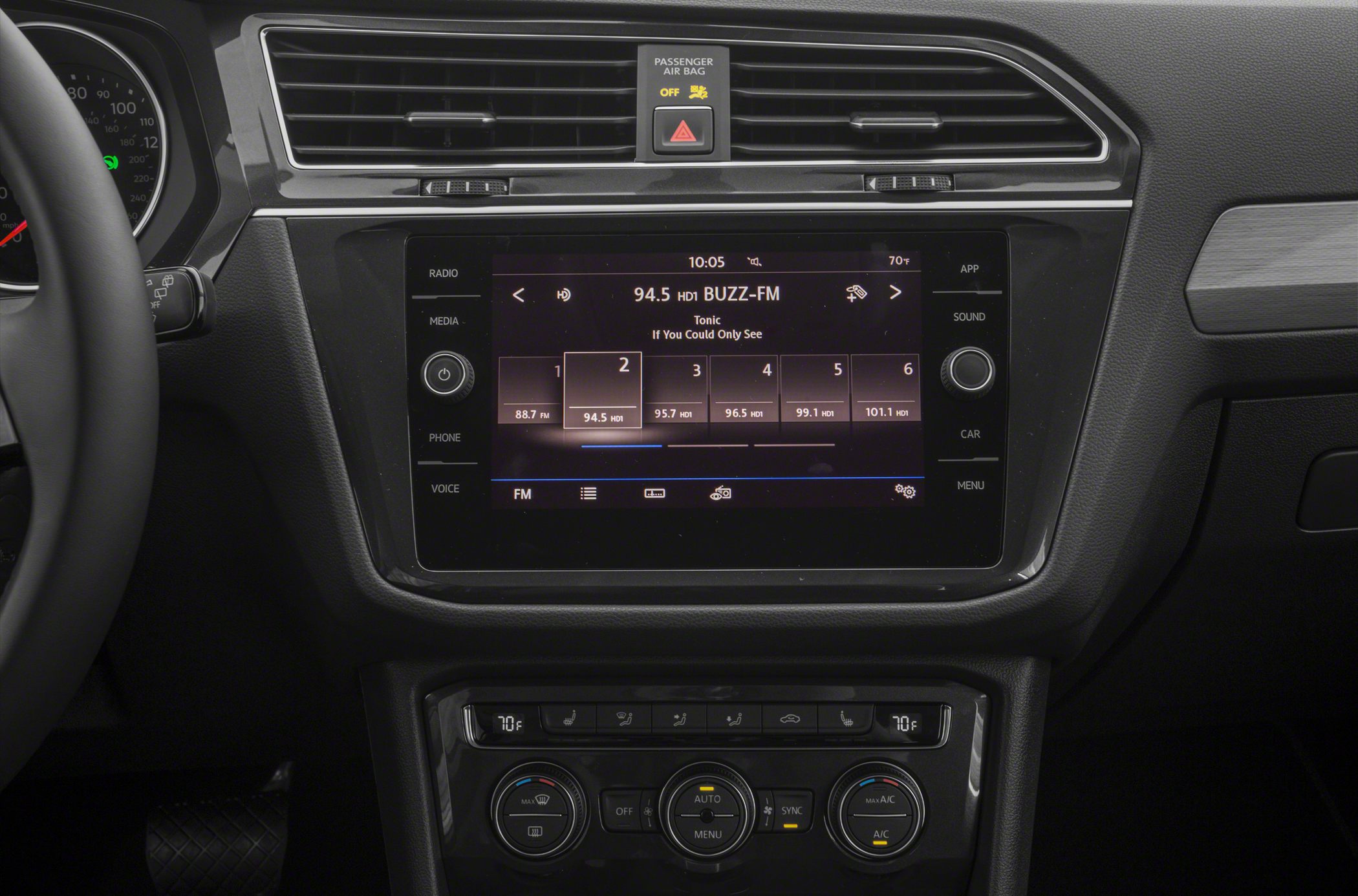 Center touchscreen infotainment and climate control panel with temperature settings and media options