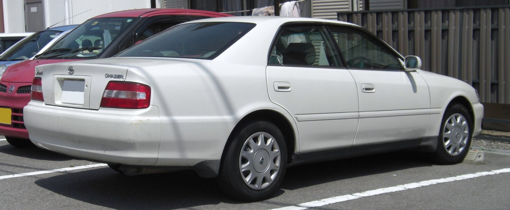 Rear side view of classic four-door sedan with distinct taillights