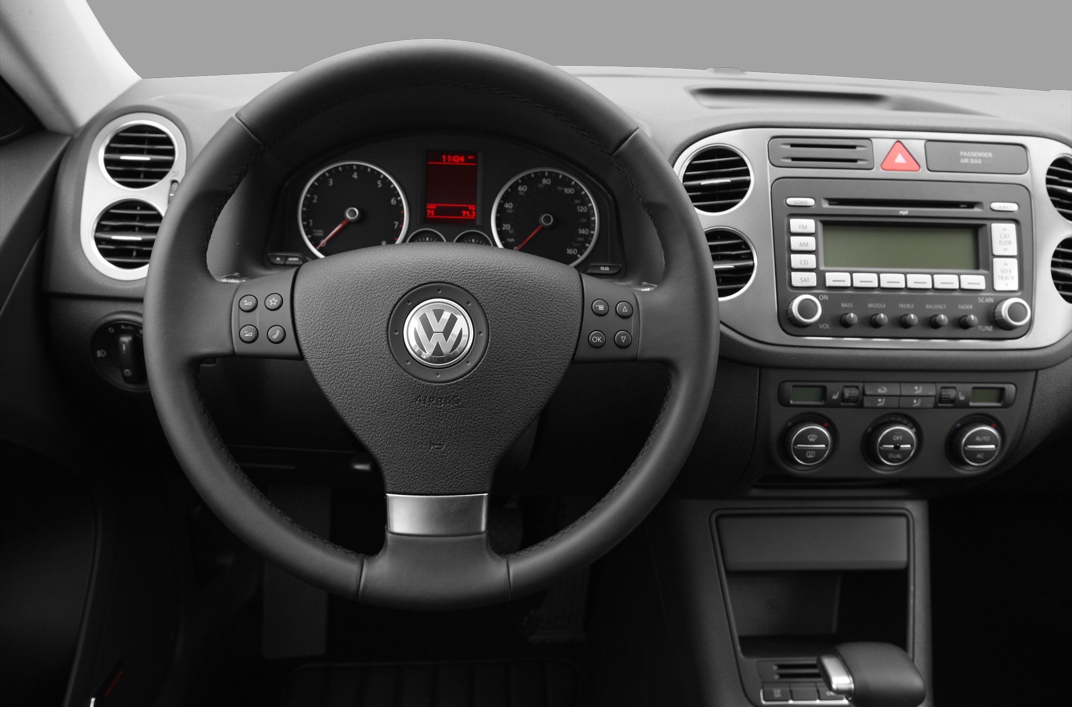 Steering wheel with controls and dashboard instrument panel.