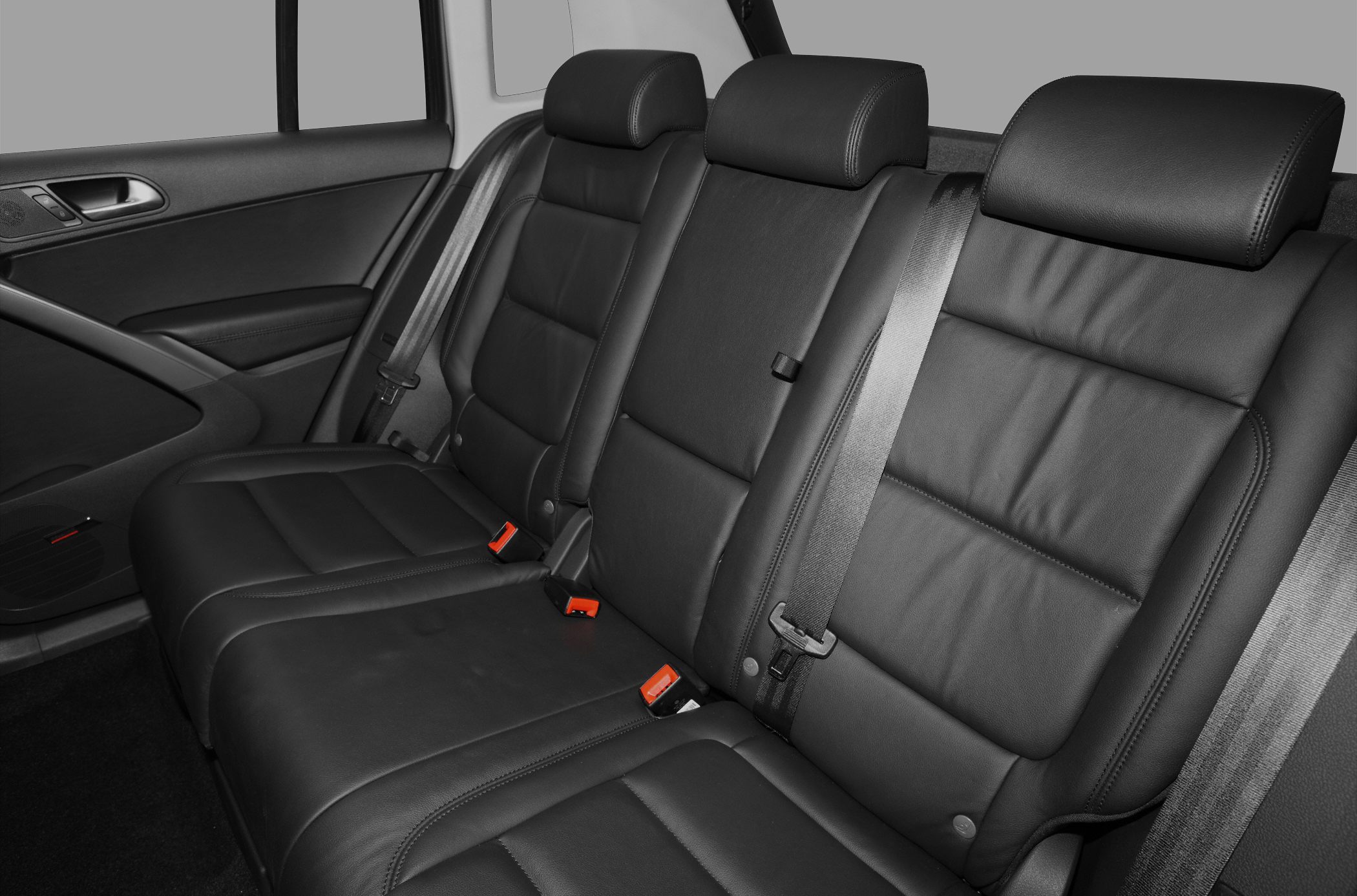 Leather rear seat upholstery with seatbelts in vehicle interior