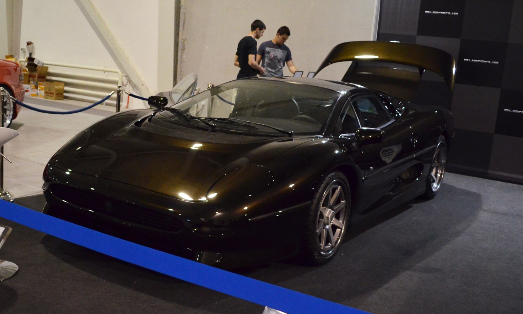 Sleek aerodynamic black sports car with raised rear spoiler