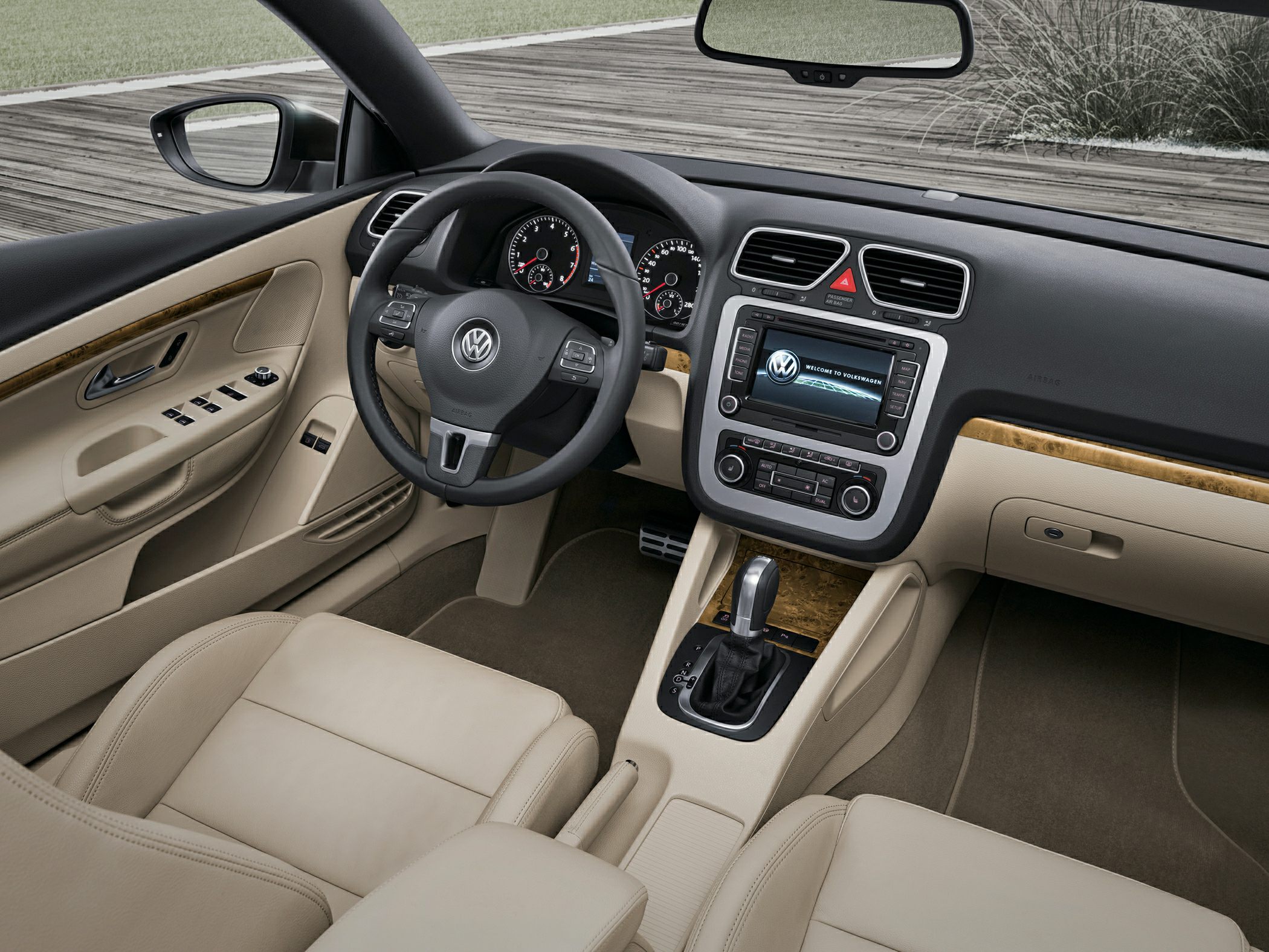 Beige interior with dashboard, steering wheel, and infotainment system