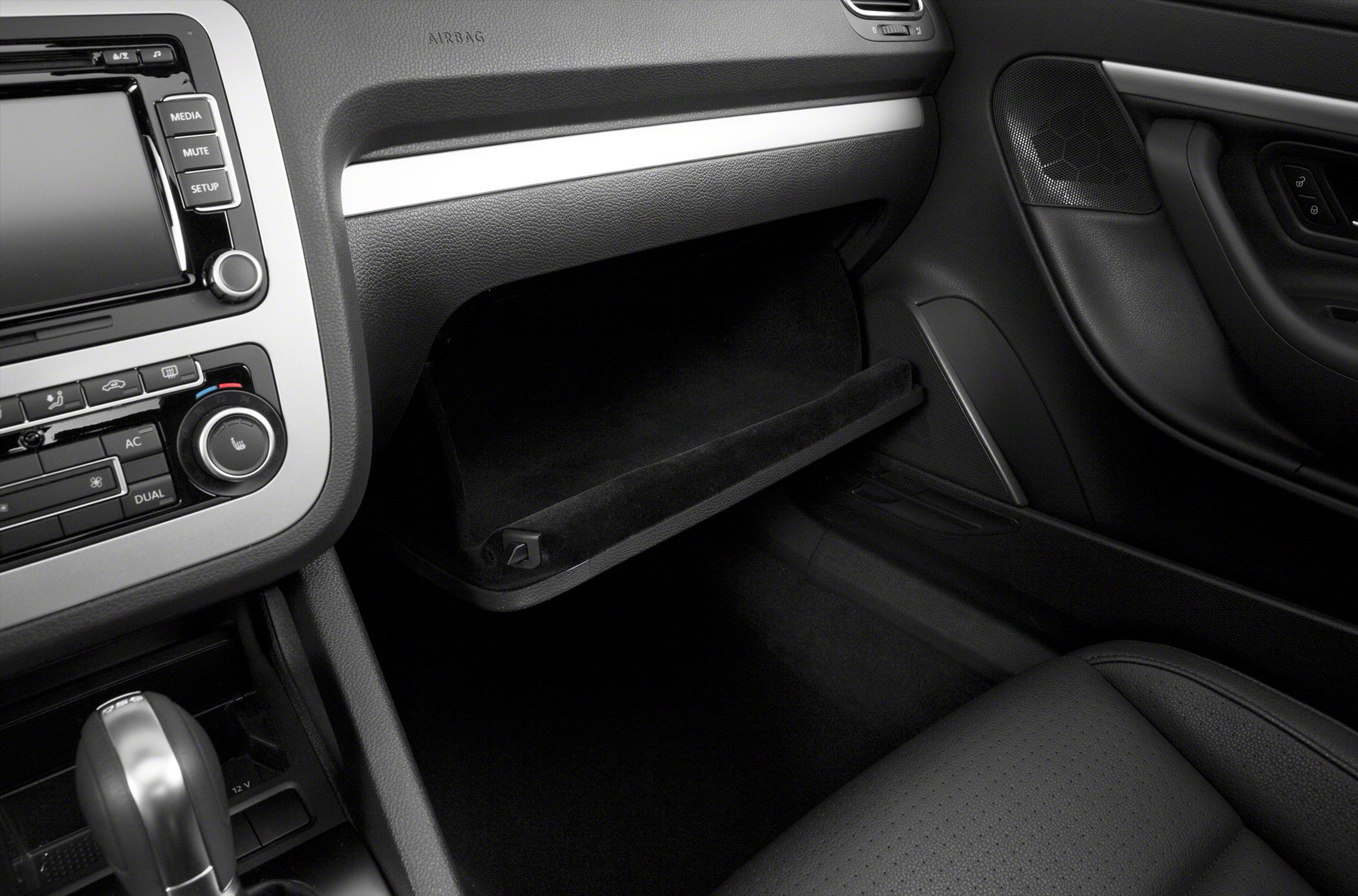 Open glove compartment and dashboard with media and climate controls