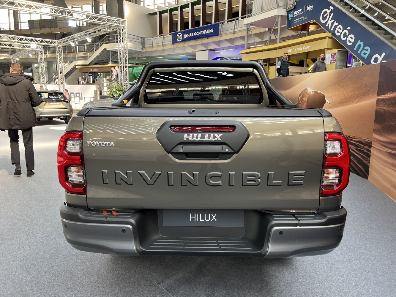 Rear view of pickup tailgate with Invincible badge and protective roll bar