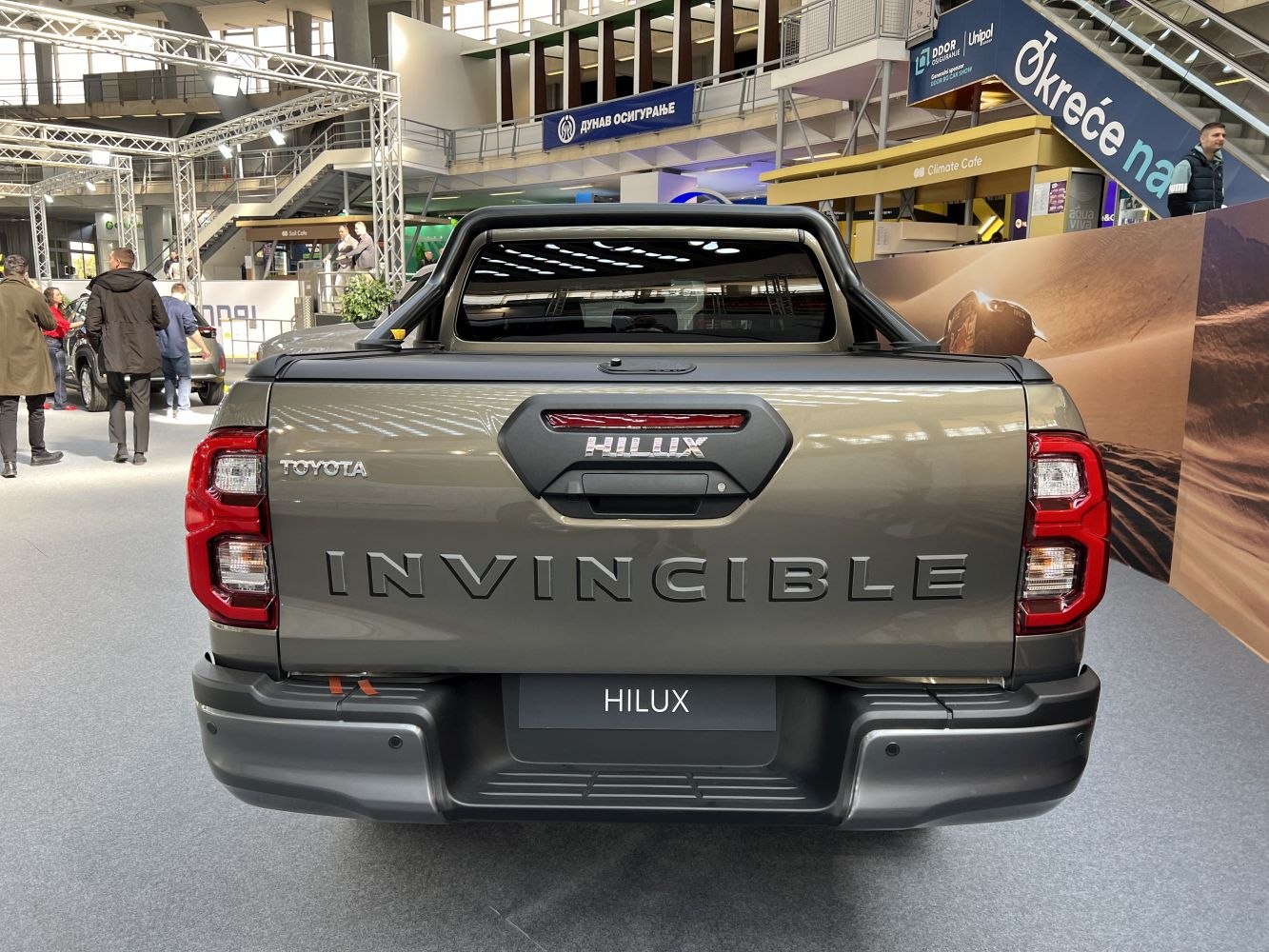 Rear tailgate and taillights of a pickup with bold Invincible lettering