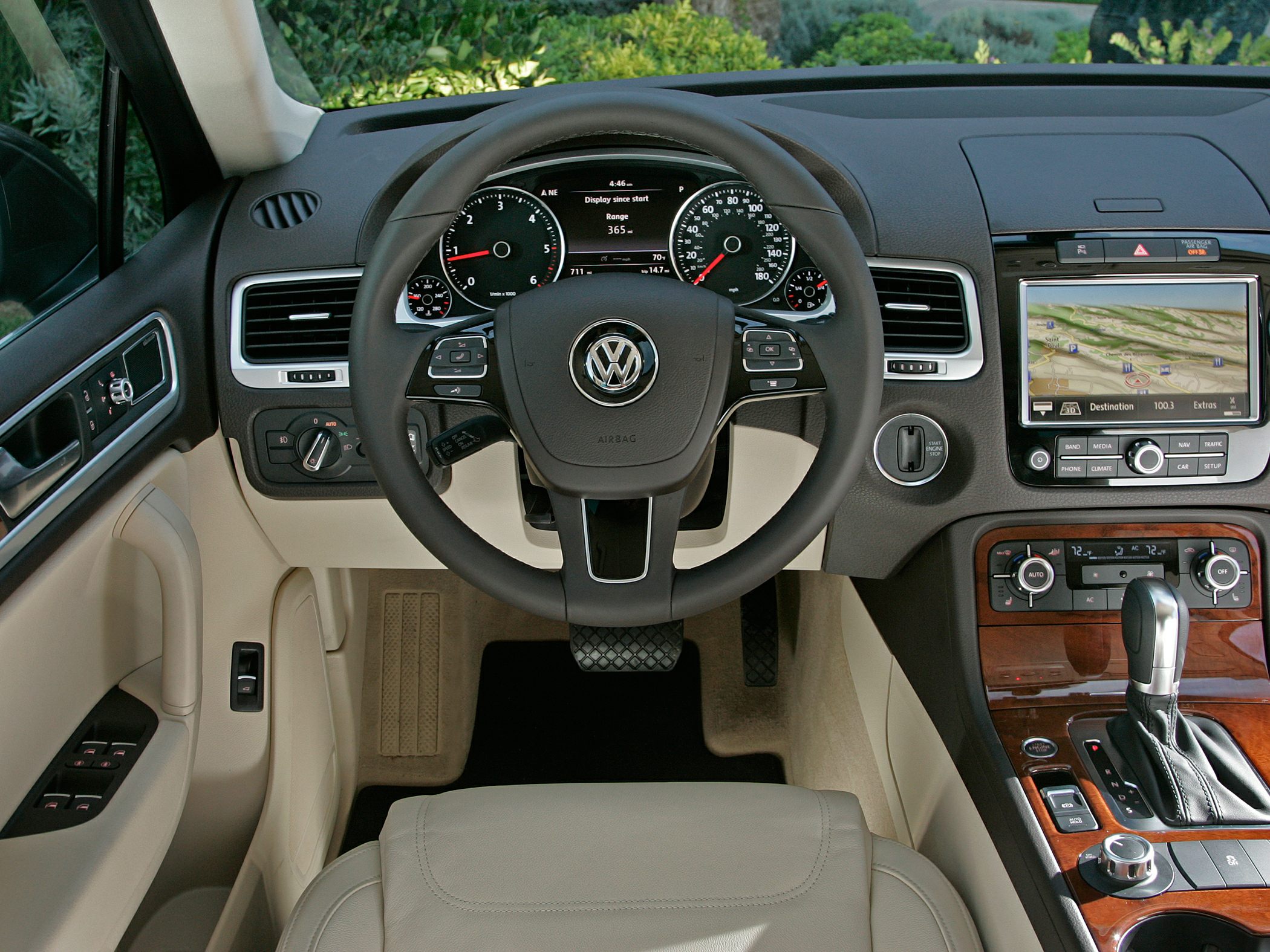 Dashboard, steering wheel, center console with navigation and wood trim