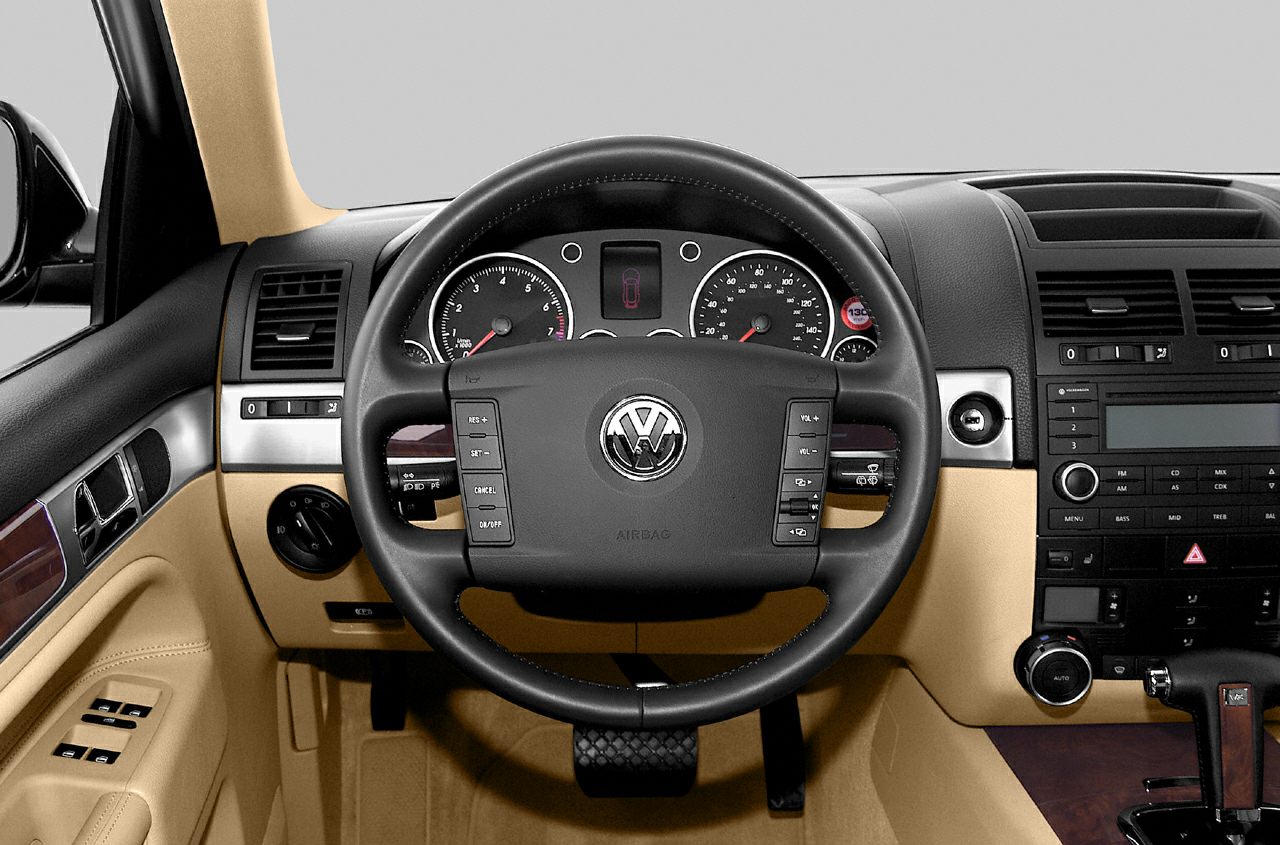 Multifunction steering wheel and detailed dashboard with beige and wood trim