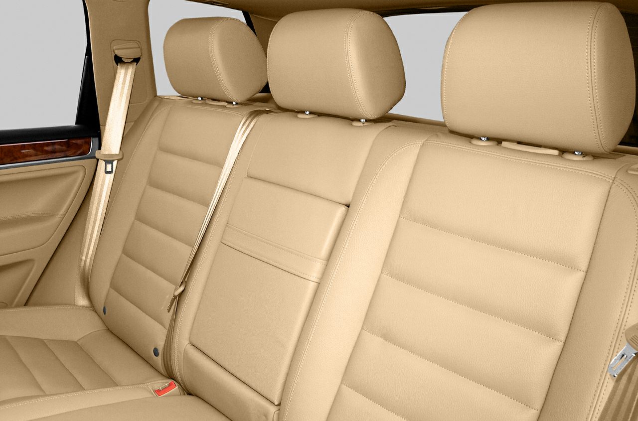 Beige leather rear seats with headrests and seatbelts