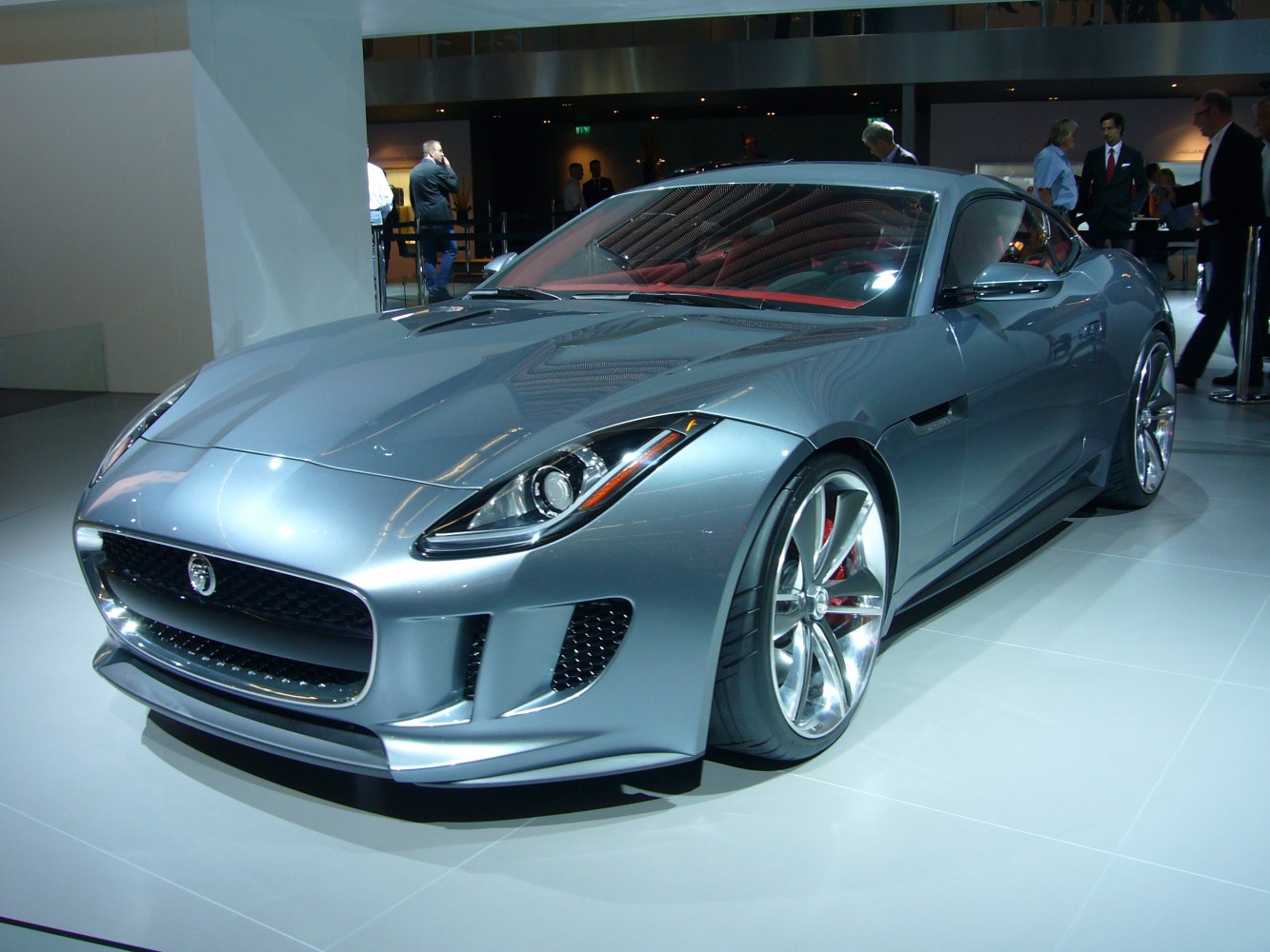 Front and side view of silver sports coupe with aerodynamic design and alloy wheels