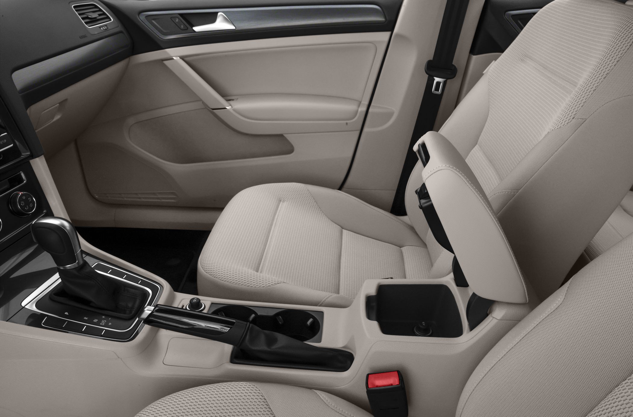 Beige front seats and center console with gear shift and armrest