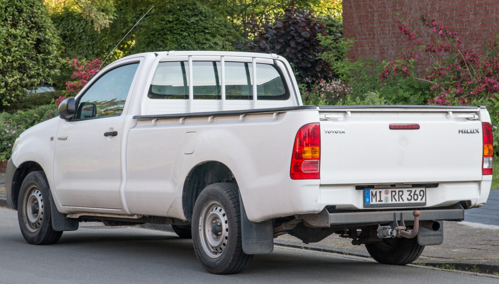 White single cab pickup with metal frame guard and steel wheels