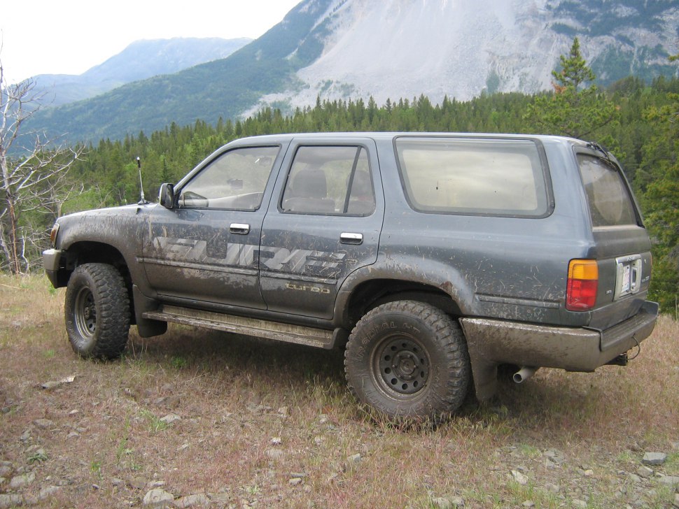 Muddy off-road SUV with large tires and raised suspension
