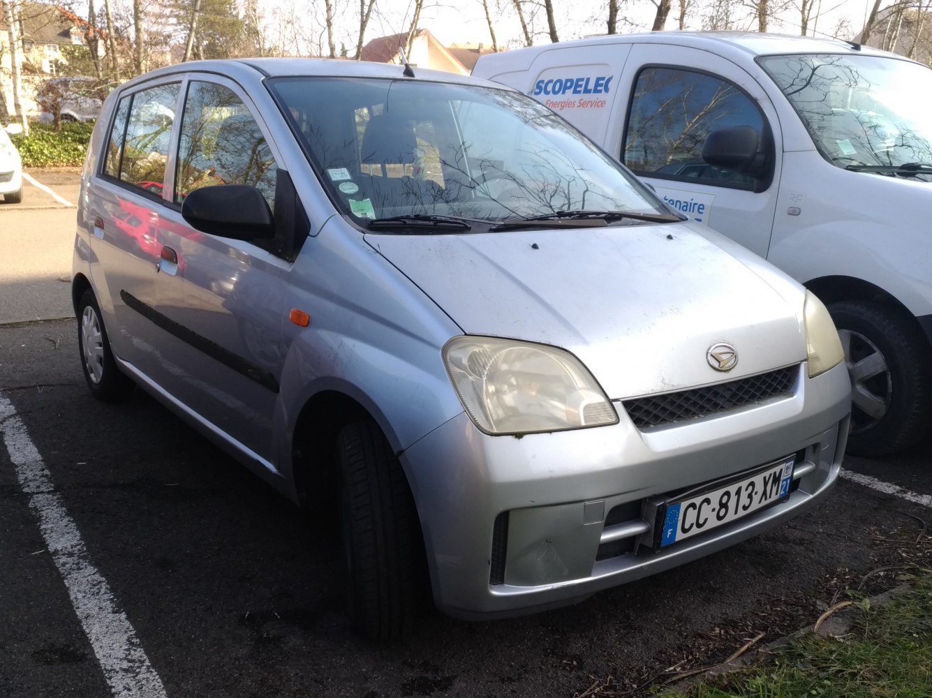 Compact silver hatchback with black side trim and clear headlights.
