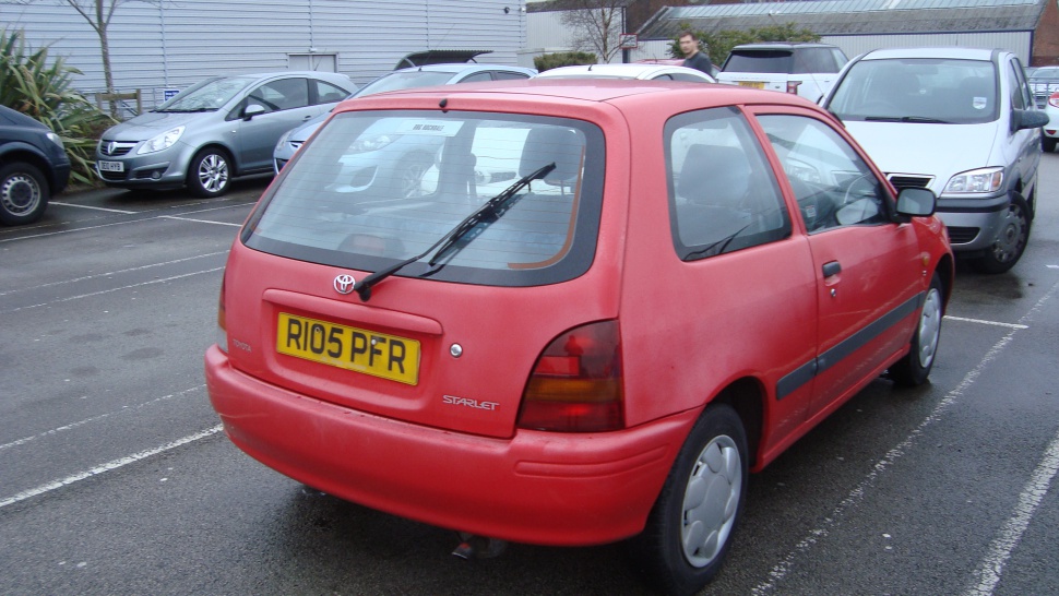 Rear three-door hatchback with rear windshield wiper and tail lights.