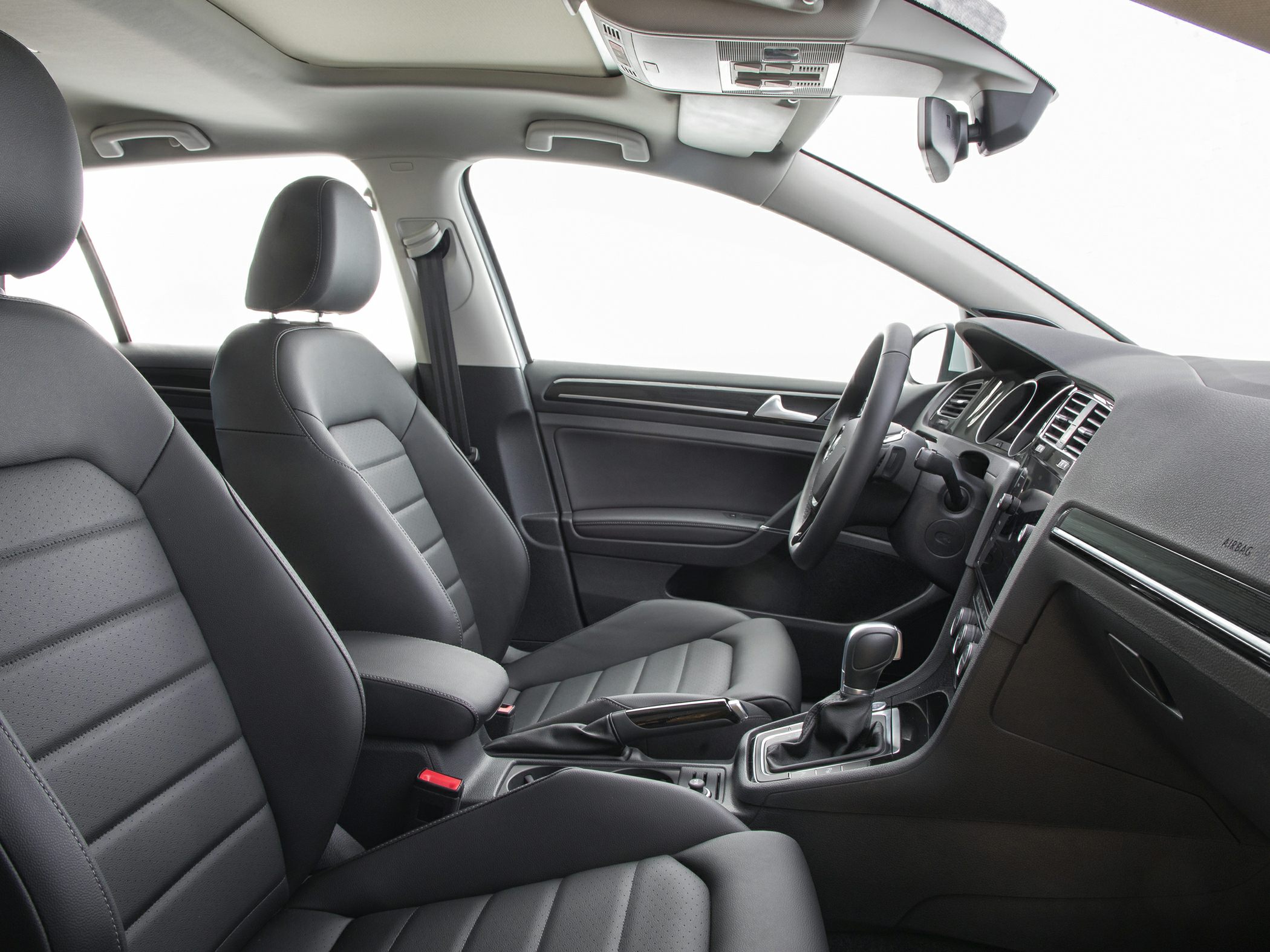 Modern car interior with premium front seats and detailed cockpit layout.