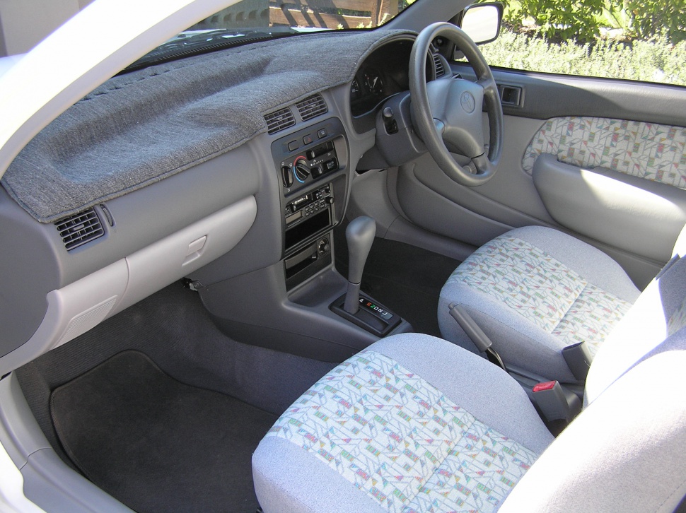 Compact car interior with fabric seats and automatic transmission