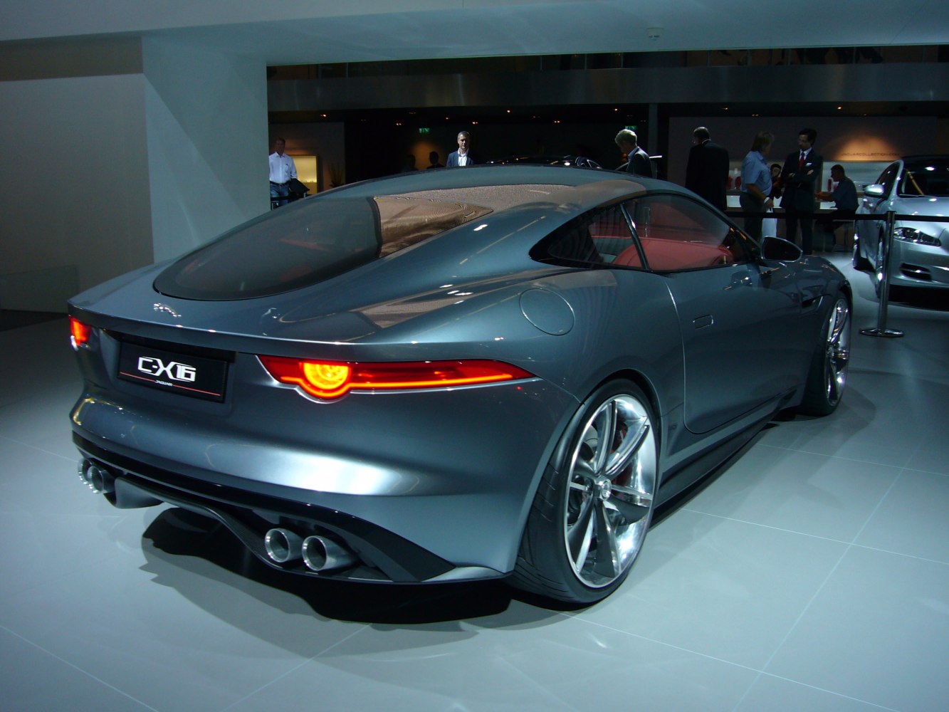 Rear view of a sleek sports coupe with distinctive tail lights and quad exhausts