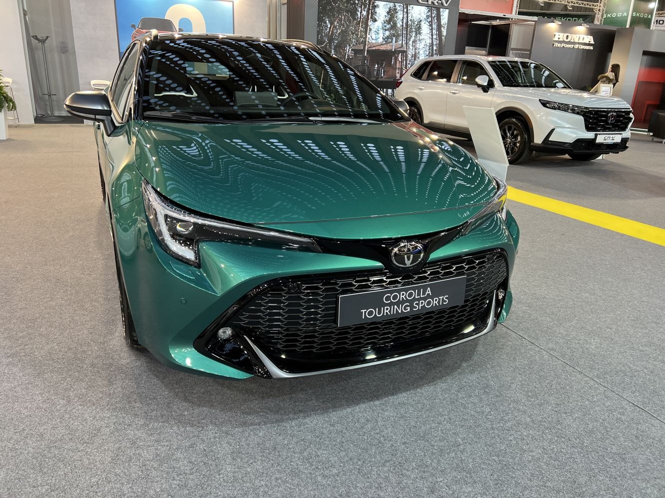 Front view of sleek hatchback with LED headlights and large grille